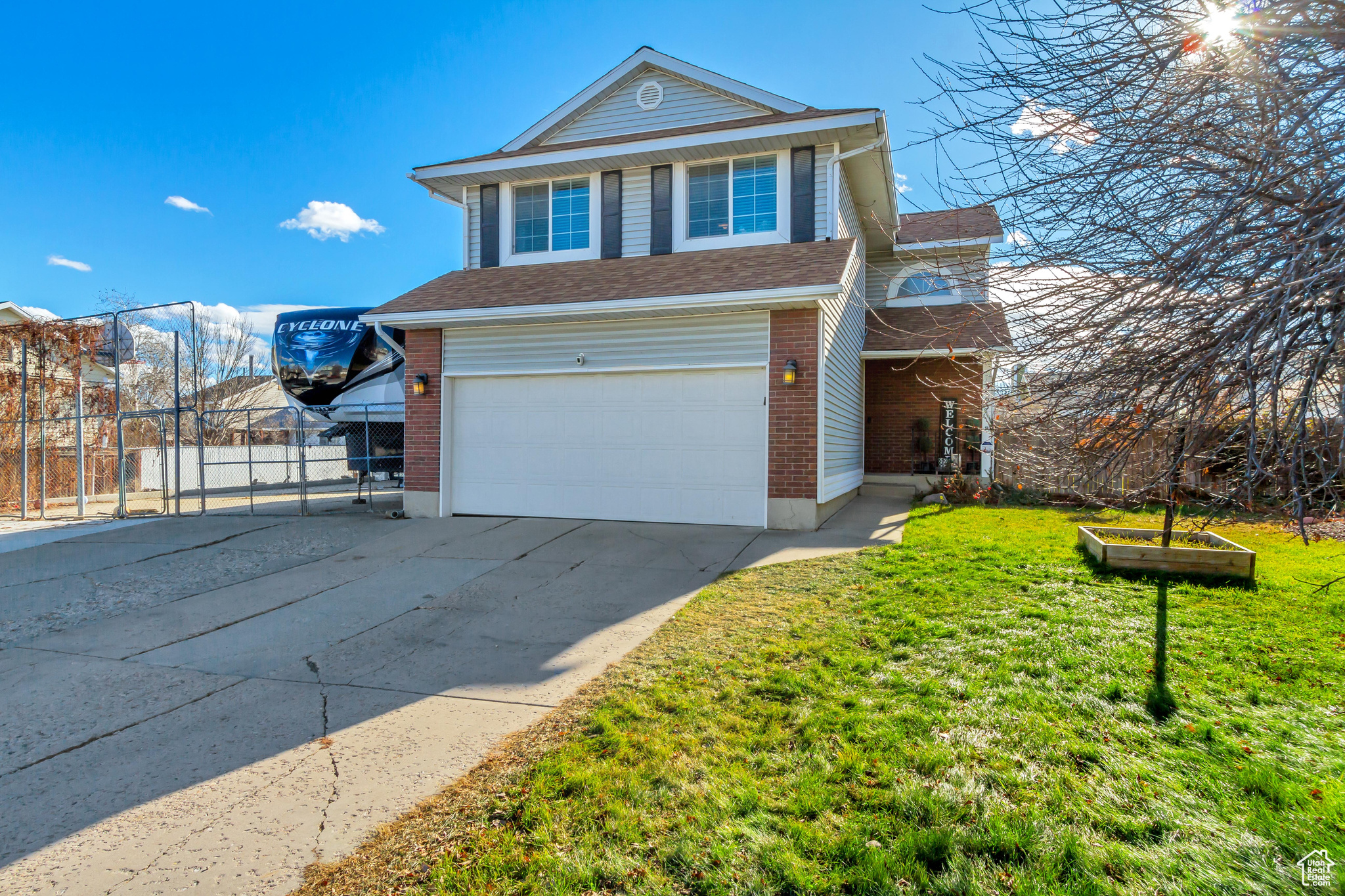 Front of property featuring a garage and a front lawn