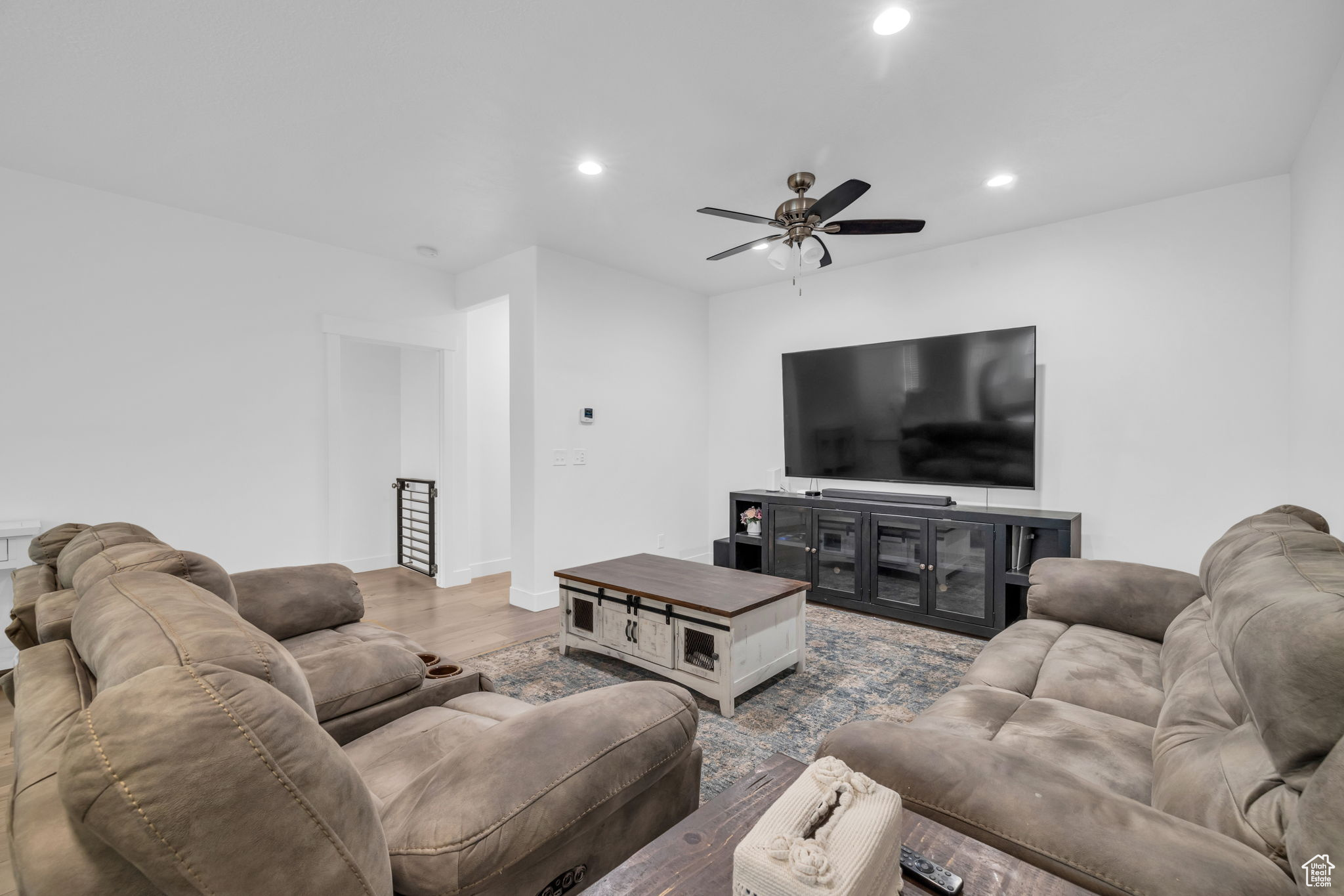 Living room featuring hardwood / wood-style floors and ceiling fan