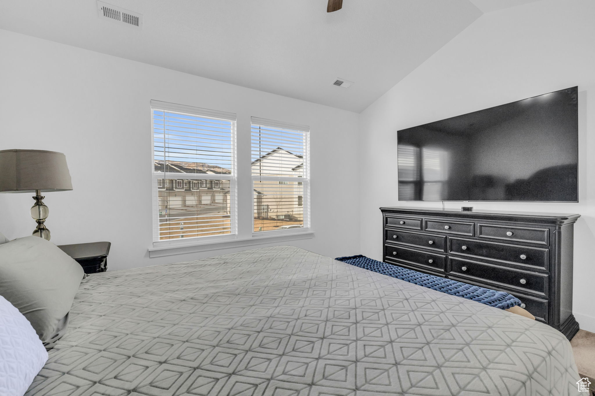 Bedroom featuring carpet flooring, ceiling fan, and vaulted ceiling