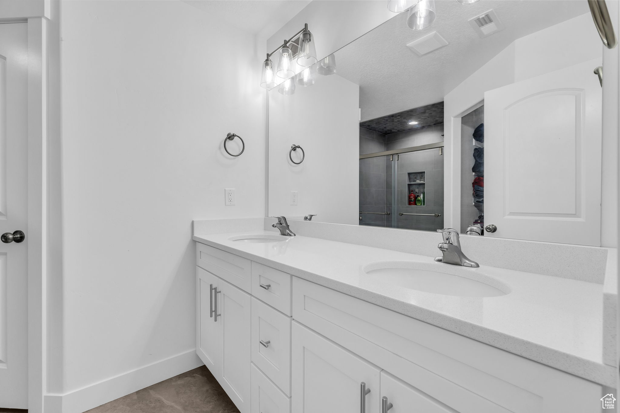 Bathroom with tile patterned flooring, vanity, and an enclosed shower