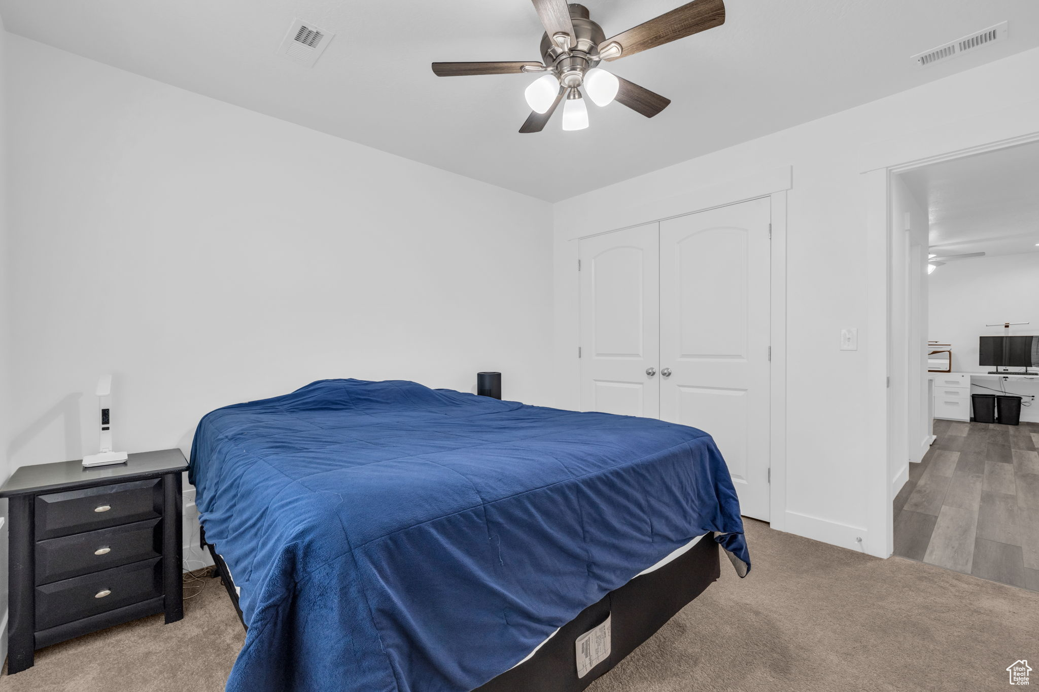 Bedroom with carpet flooring, ceiling fan, and a closet