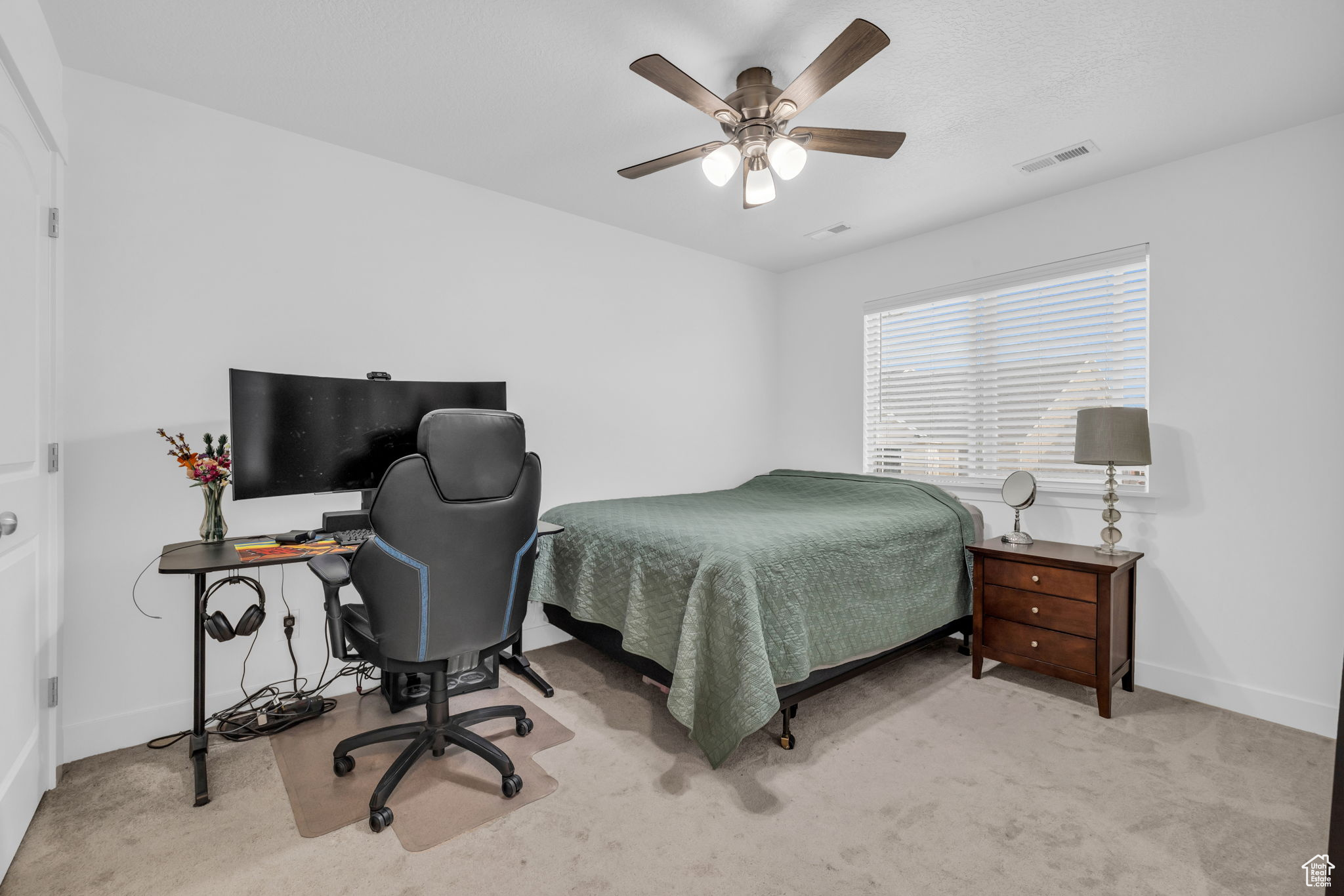 Bedroom with light carpet and ceiling fan