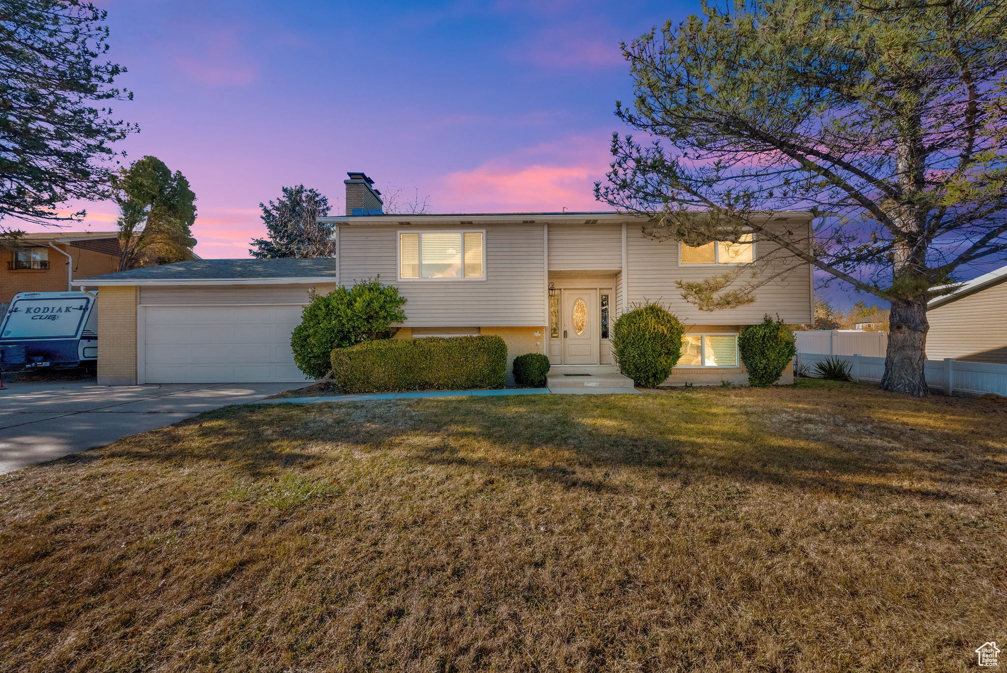 Bi-level home with a garage and a yard