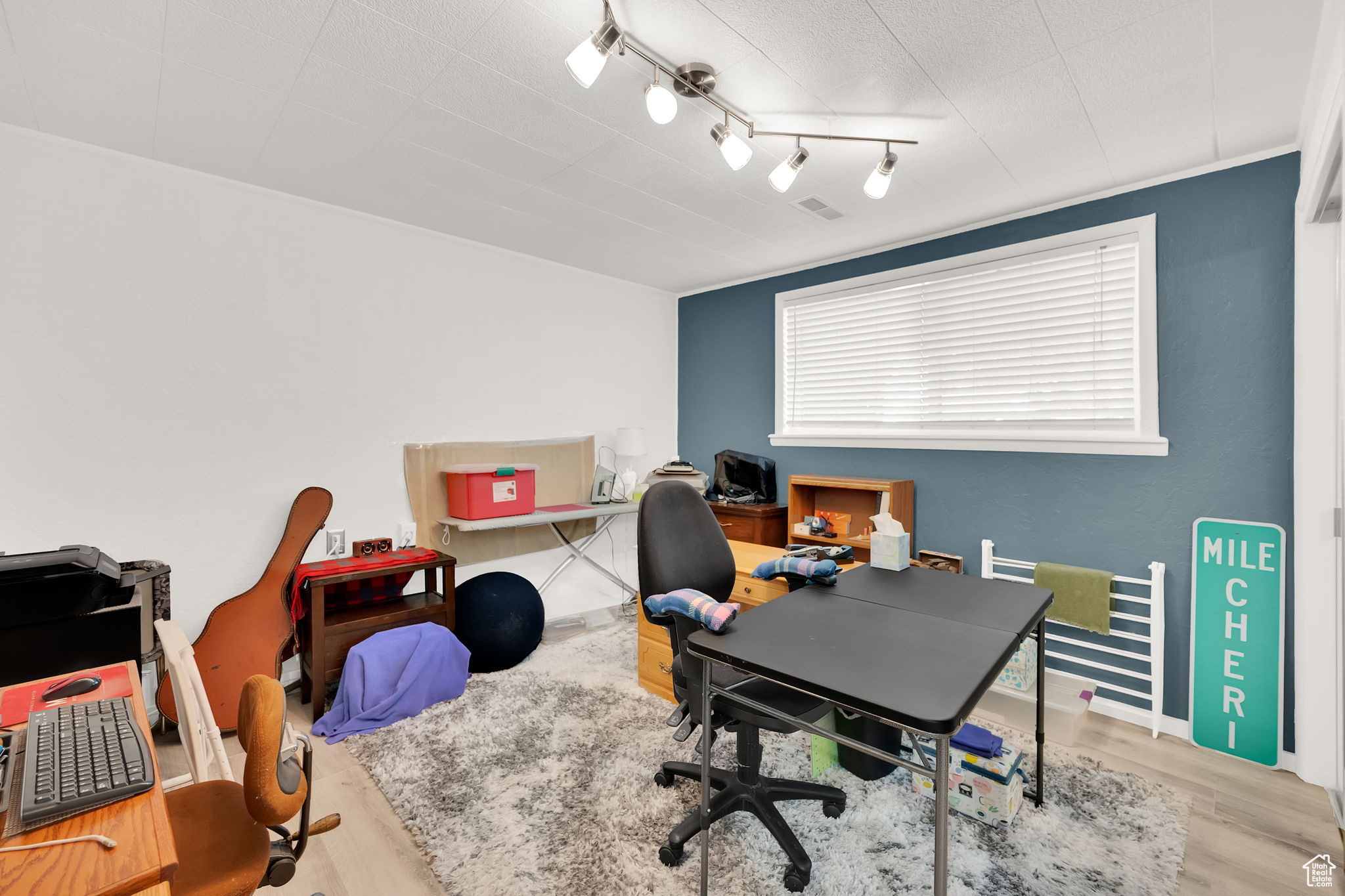 Office area featuring light hardwood / wood-style floors and rail lighting