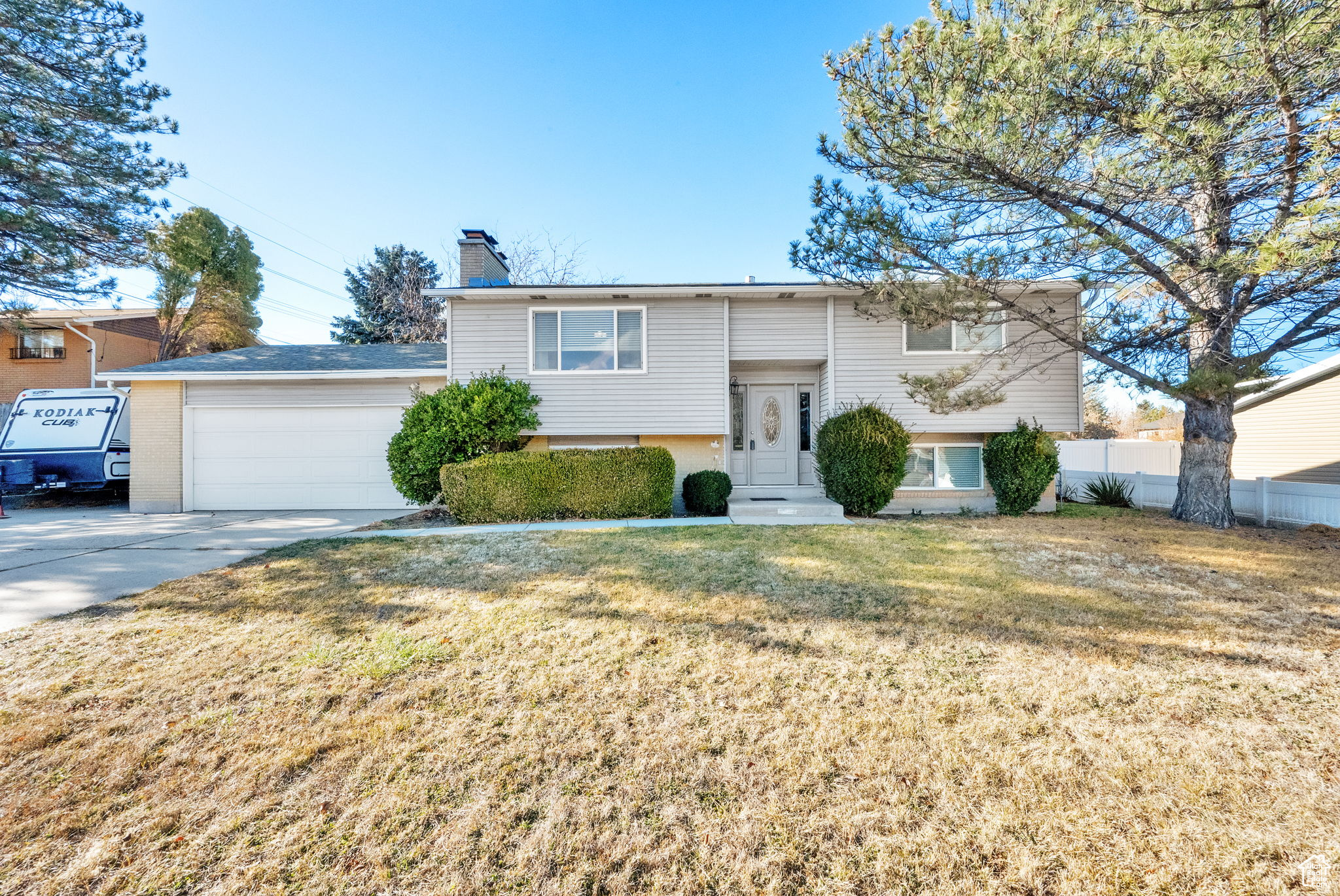 Bi-level home featuring a front lawn and a garage