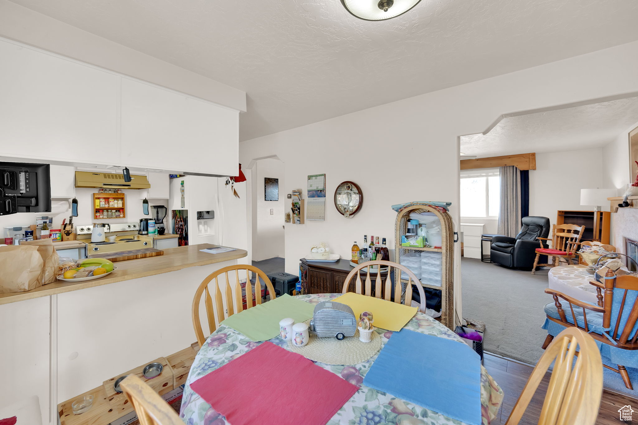 Carpeted dining room featuring a textured ceiling