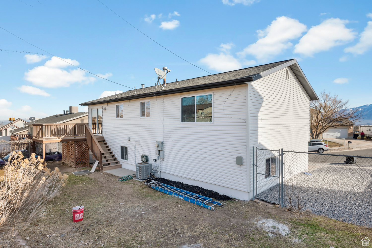 Rear view of house featuring a deck and central AC unit