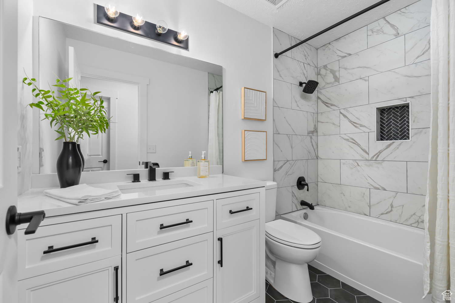 Full bathroom featuring tile patterned flooring, vanity, shower / bath combination with curtain, and toilet