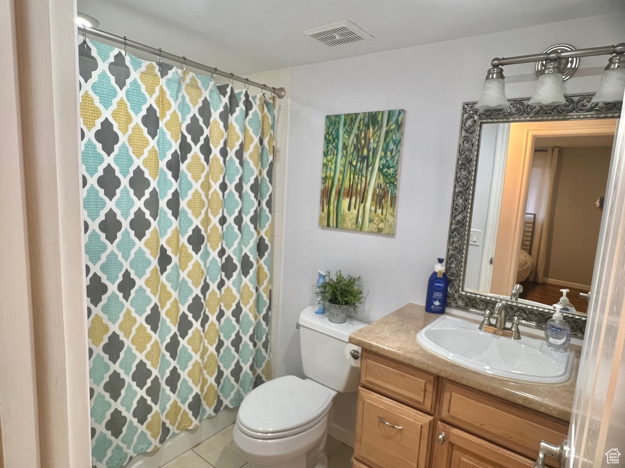 Bathroom featuring tile patterned floors, vanity, and toilet