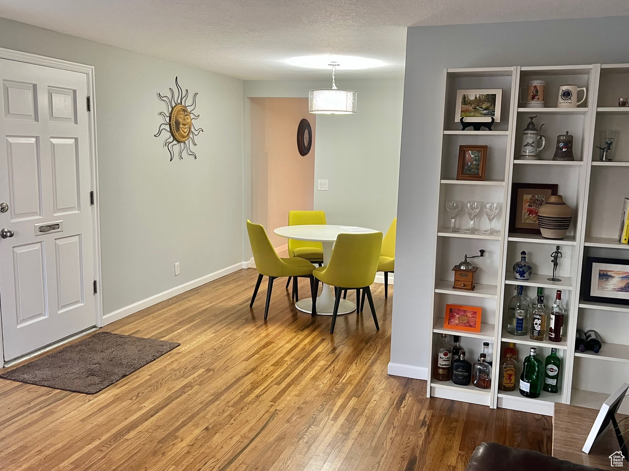 Dining room with hardwood / wood-style flooring and a textured ceiling