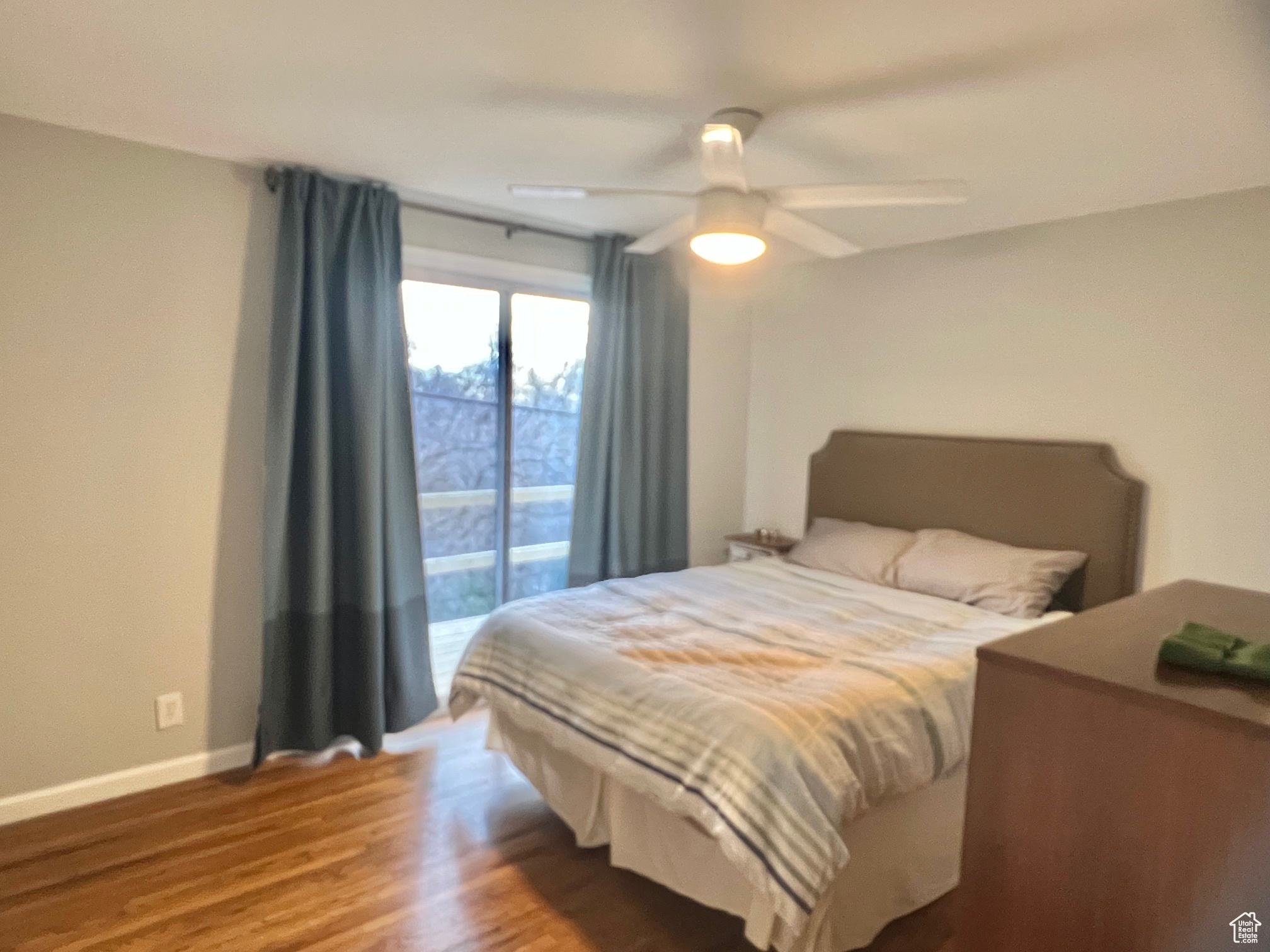 Bedroom featuring ceiling fan and hardwood / wood-style floors