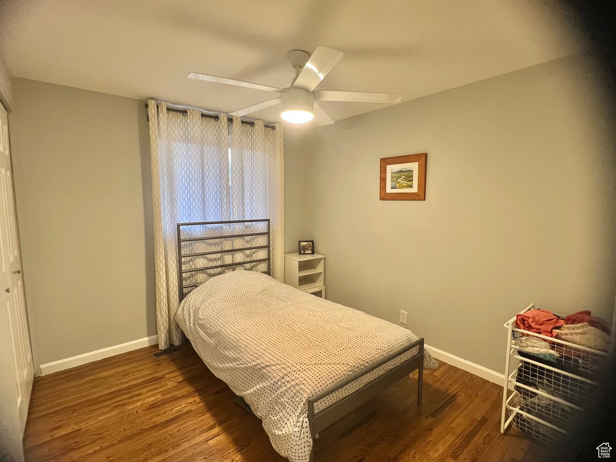 Bedroom with dark hardwood / wood-style flooring and ceiling fan