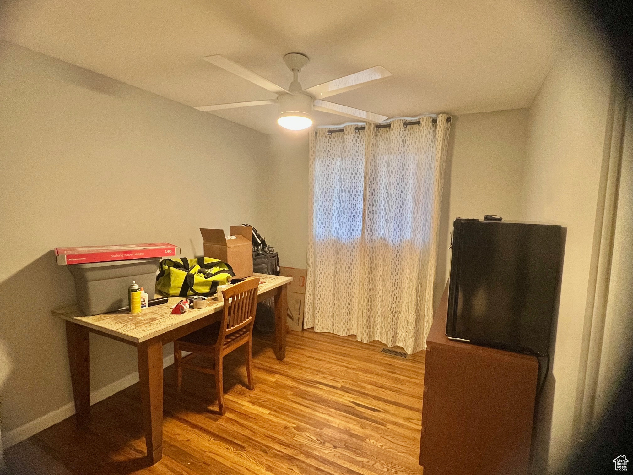 Home office featuring ceiling fan and light hardwood / wood-style flooring