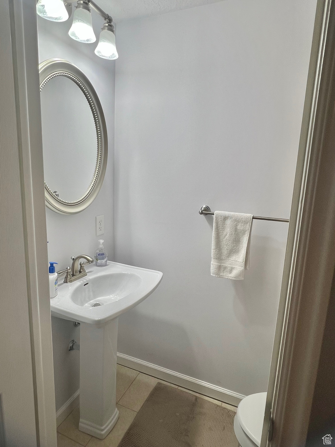 Bathroom featuring tile patterned flooring and toilet