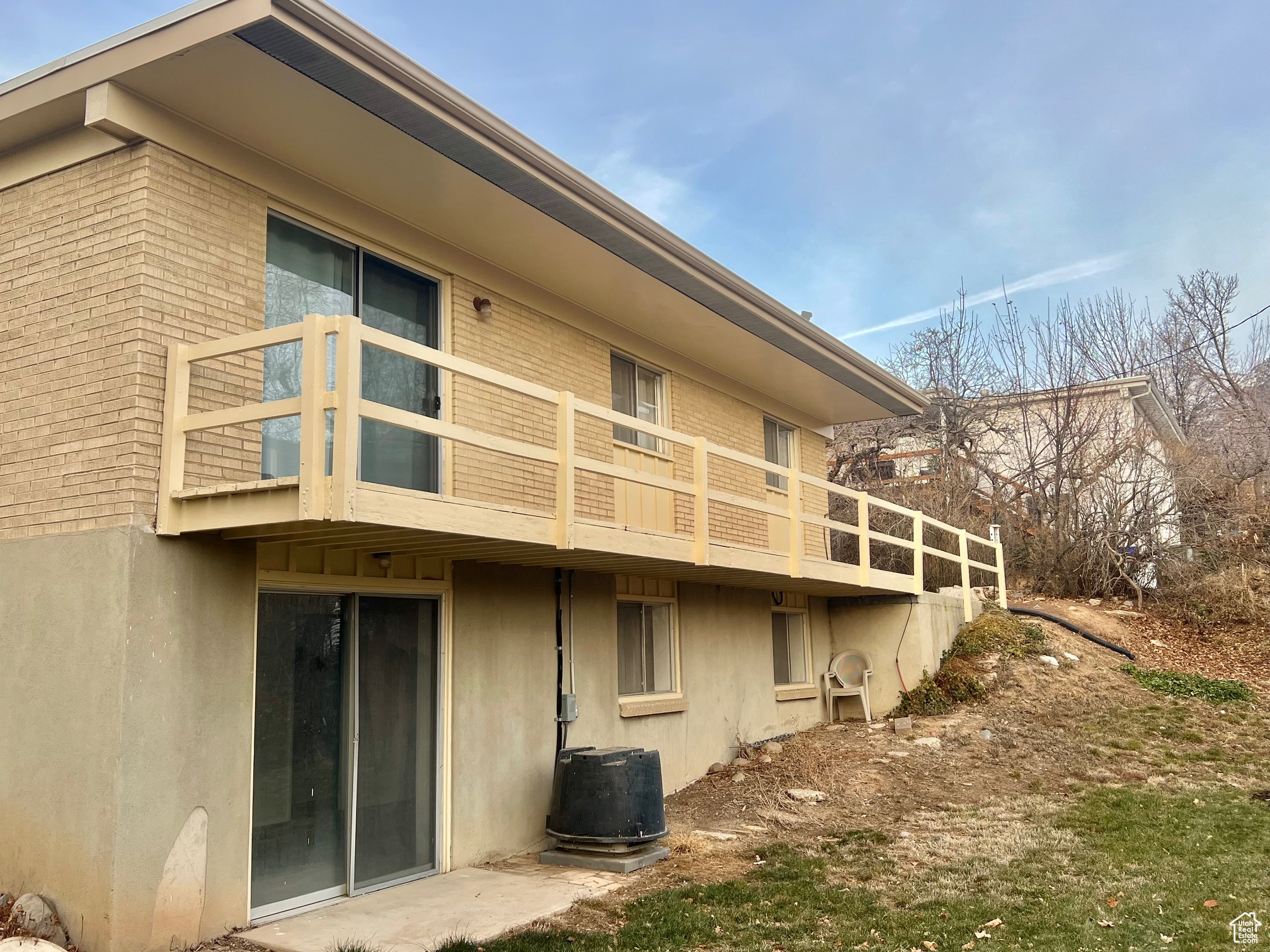 View of side of property with a balcony and central air condition unit