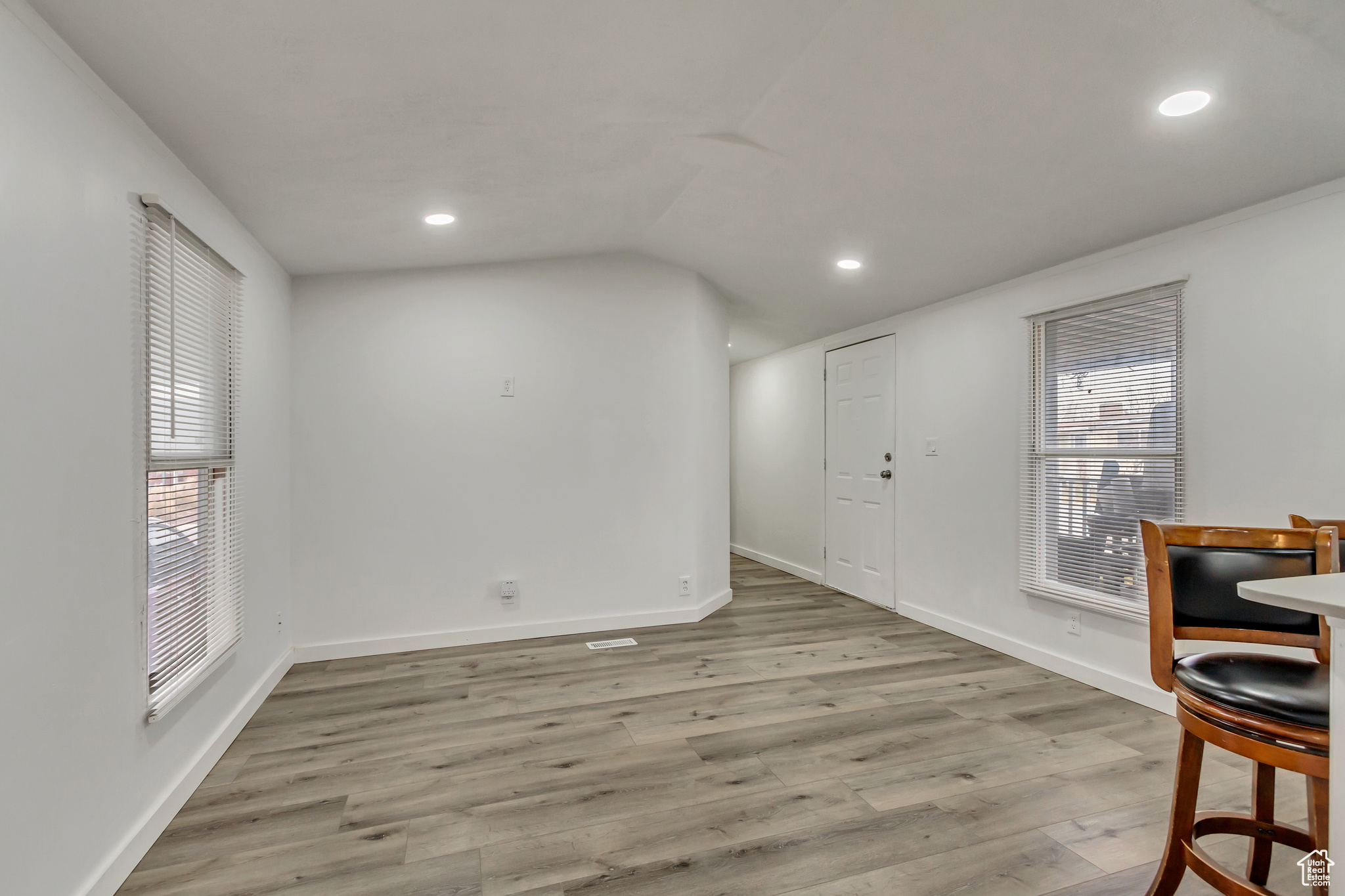 Dining space featuring light hardwood / wood-style floors, plenty of natural light, and lofted ceiling