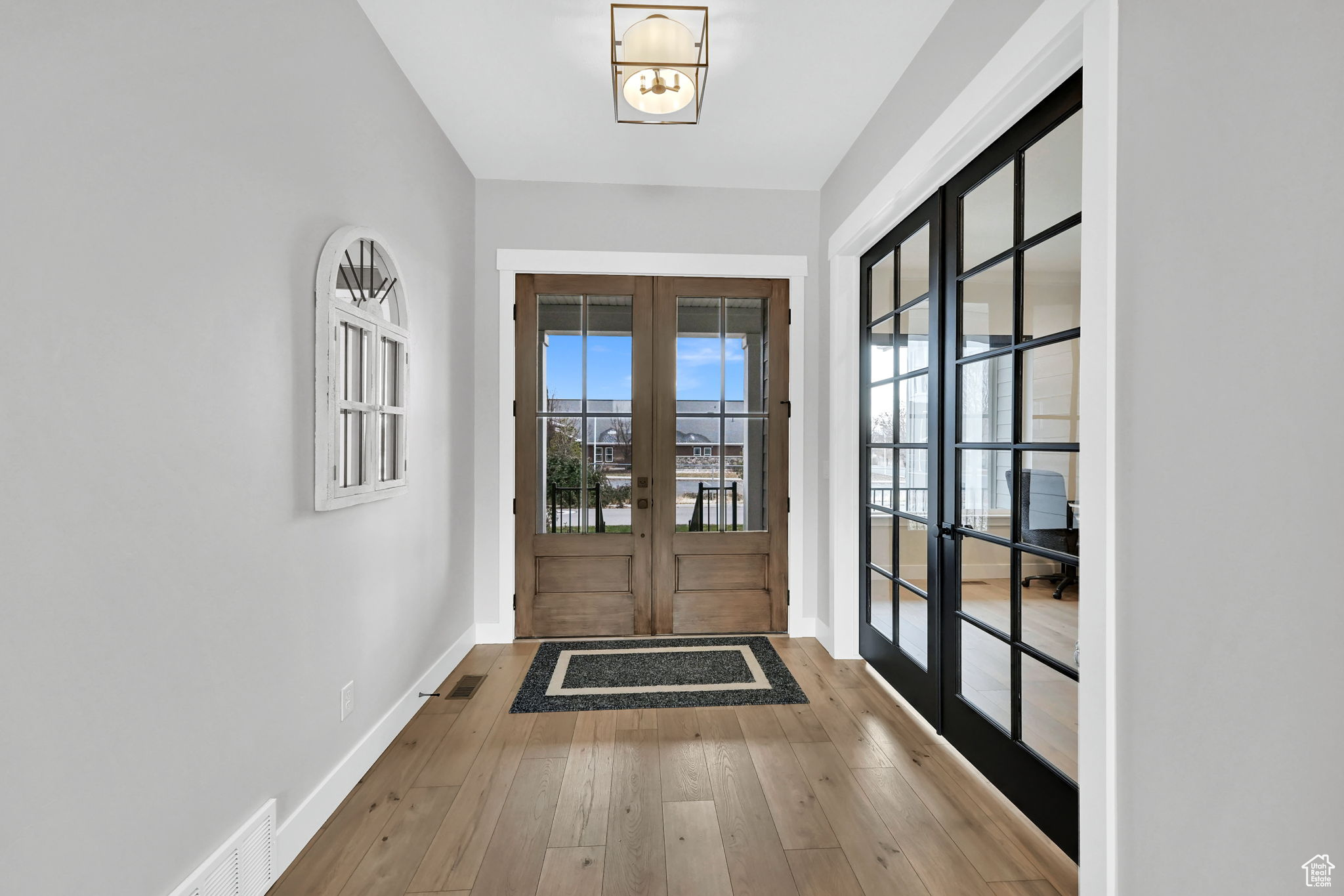 Double front door entry with French doors leading to office/den