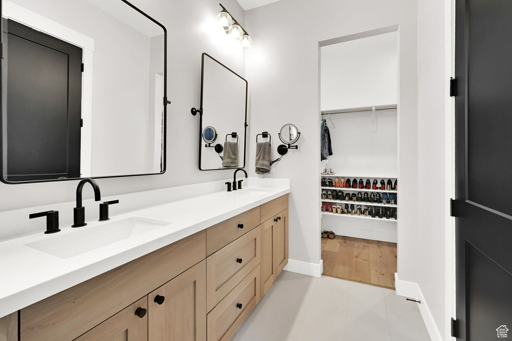 Primary Bathroom with double sinks including a view of the large walk-in closet