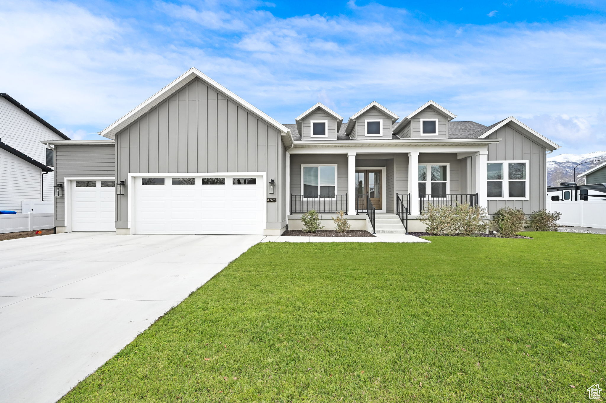 View of front facade with a lovely landscaped yard, porch, 3-car garage plus RV Parking space