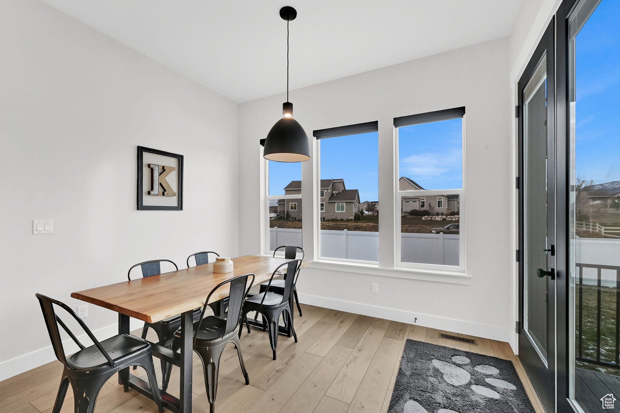 Enormous Dining Space with light hardwood / wood-style flooring