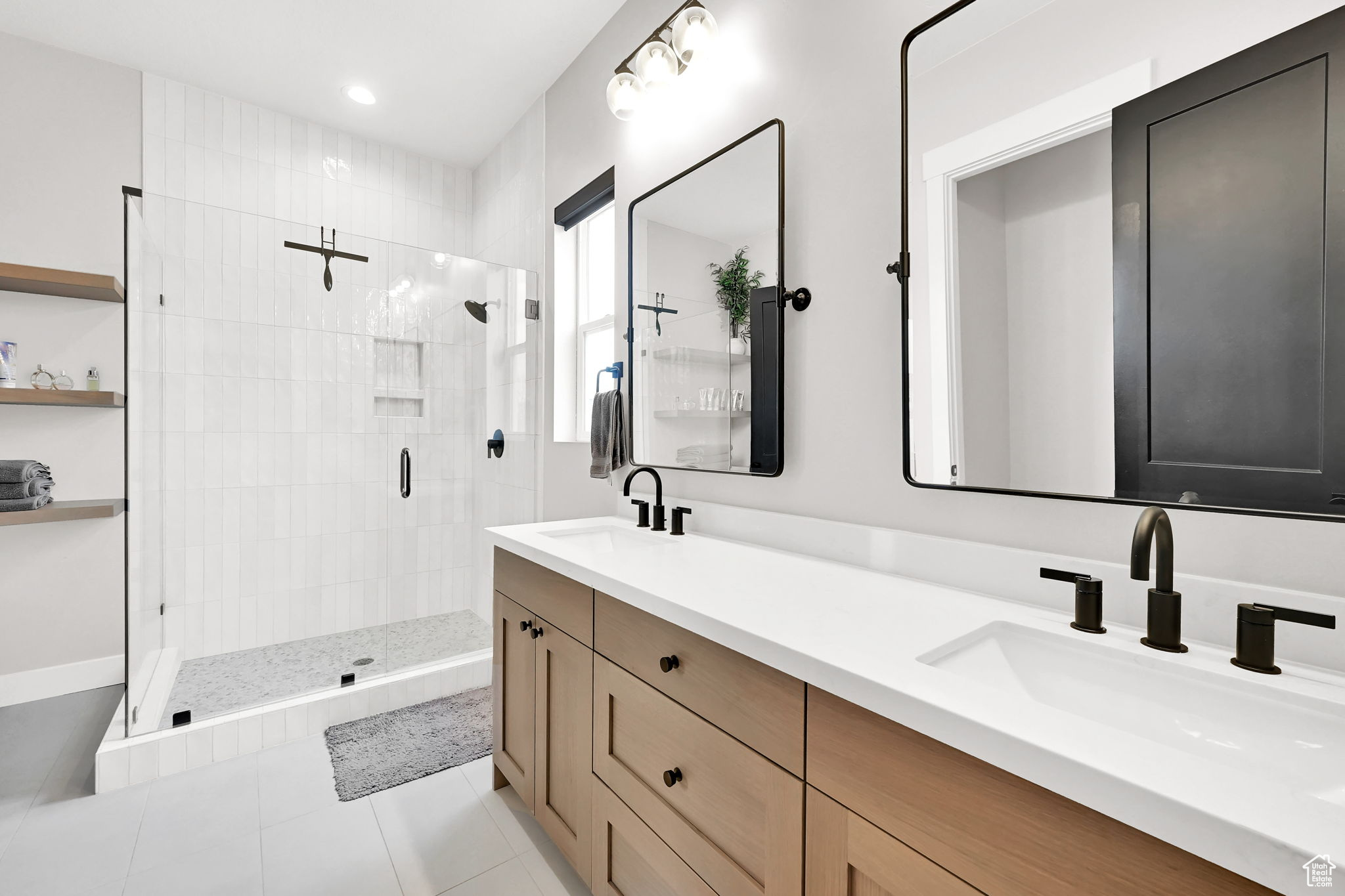 Main Bathroom featuring tile patterned floors, vanity, and an enclosed shower