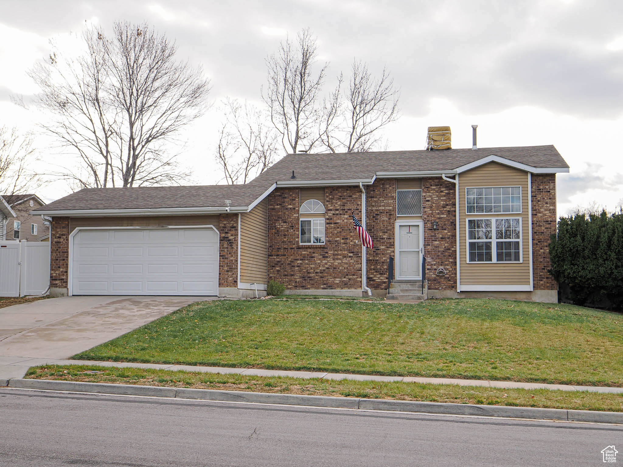 Single story home with a front lawn and a garage