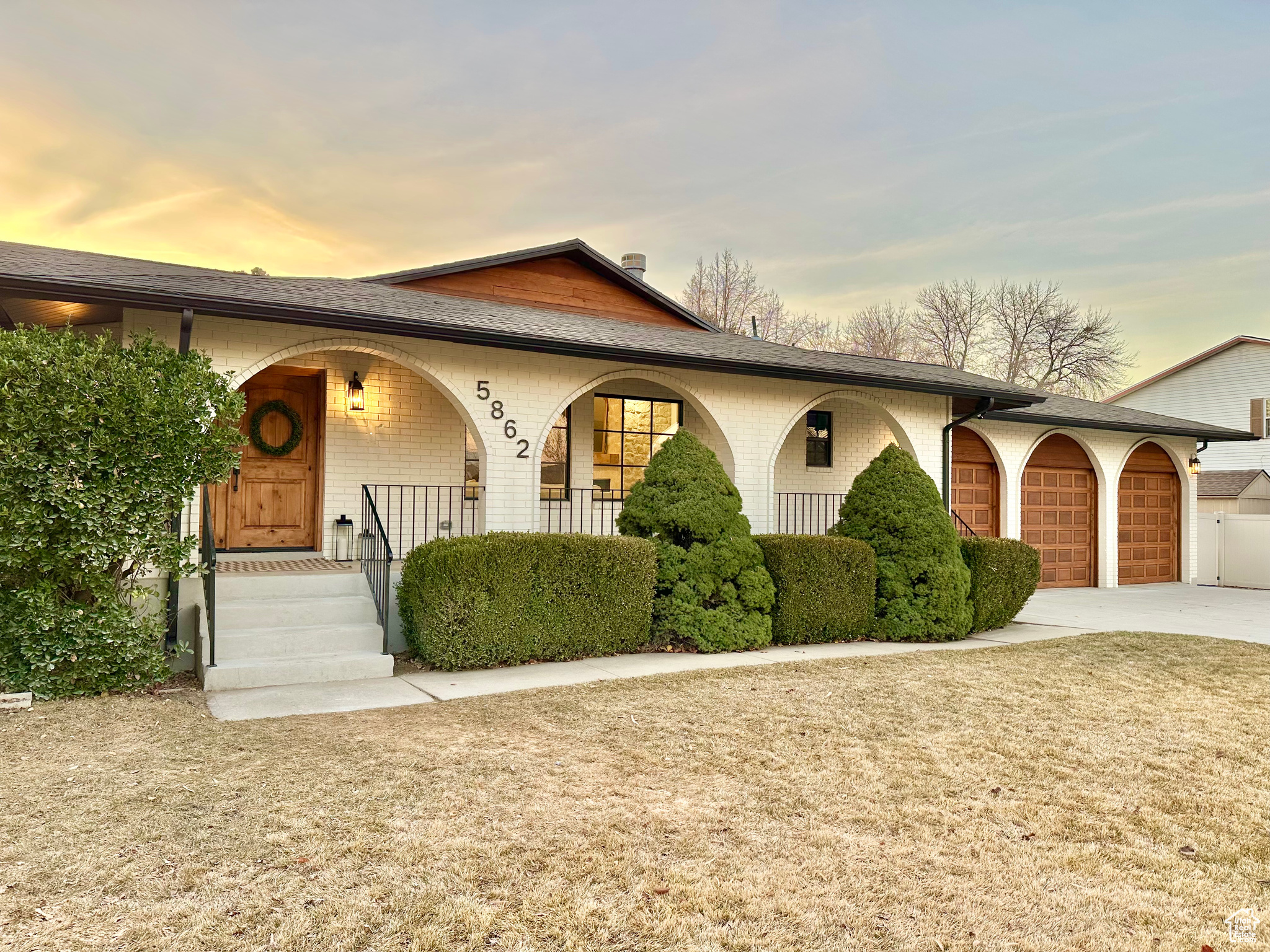 View of front of home with covered porch and a garage