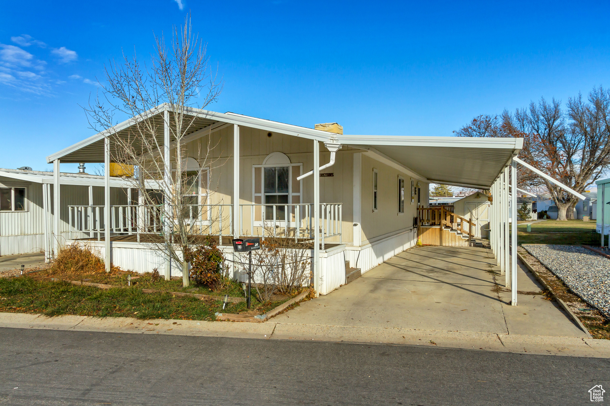 Manufactured / mobile home featuring a porch and a carport