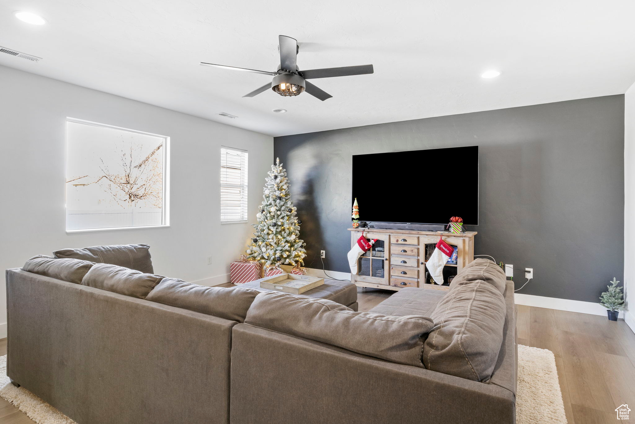 Living room featuring light hardwood / wood-style floors and ceiling fan