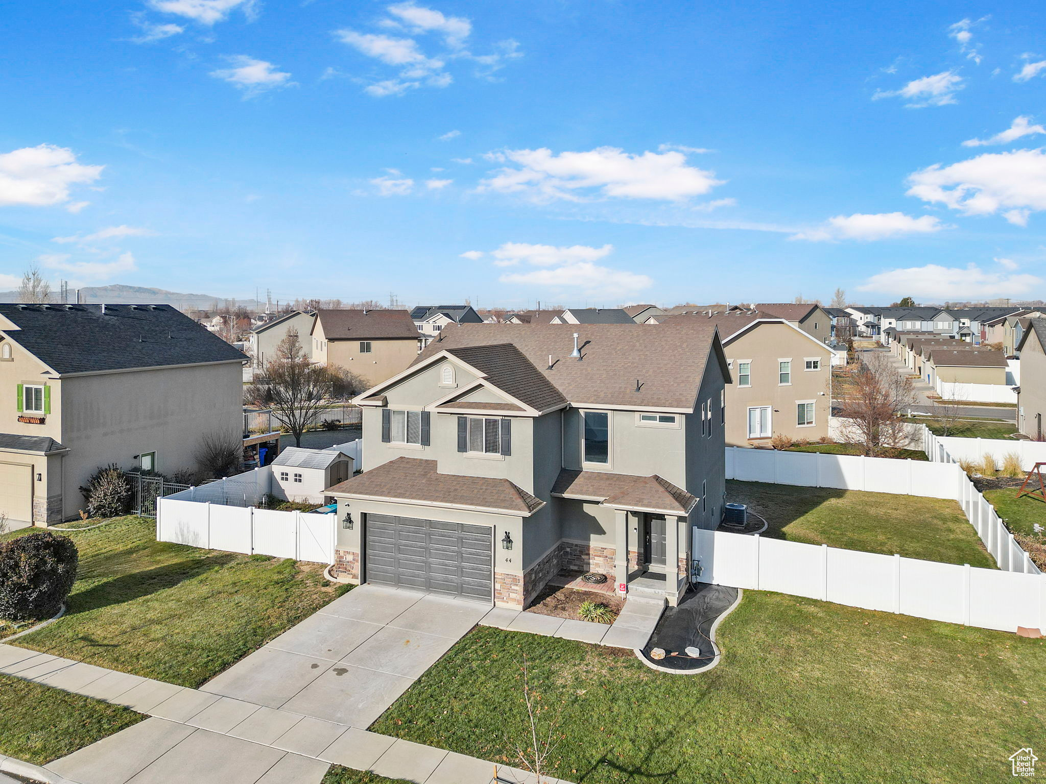 View of front of property with a front lawn and a garage