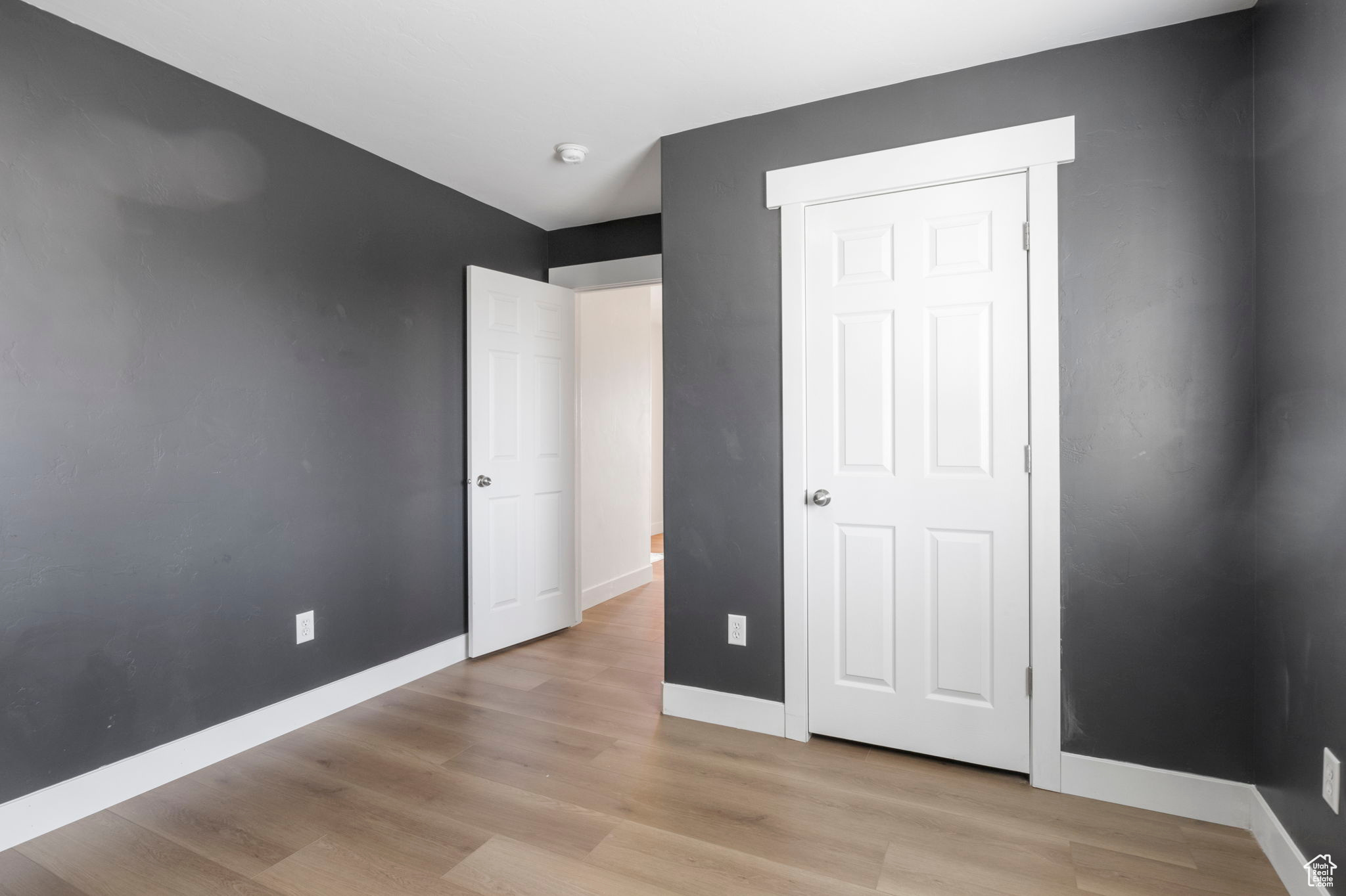 Unfurnished bedroom featuring light hardwood / wood-style floors and a closet