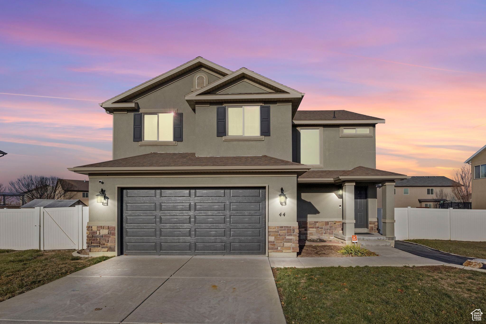 Front facade with a lawn and a garage