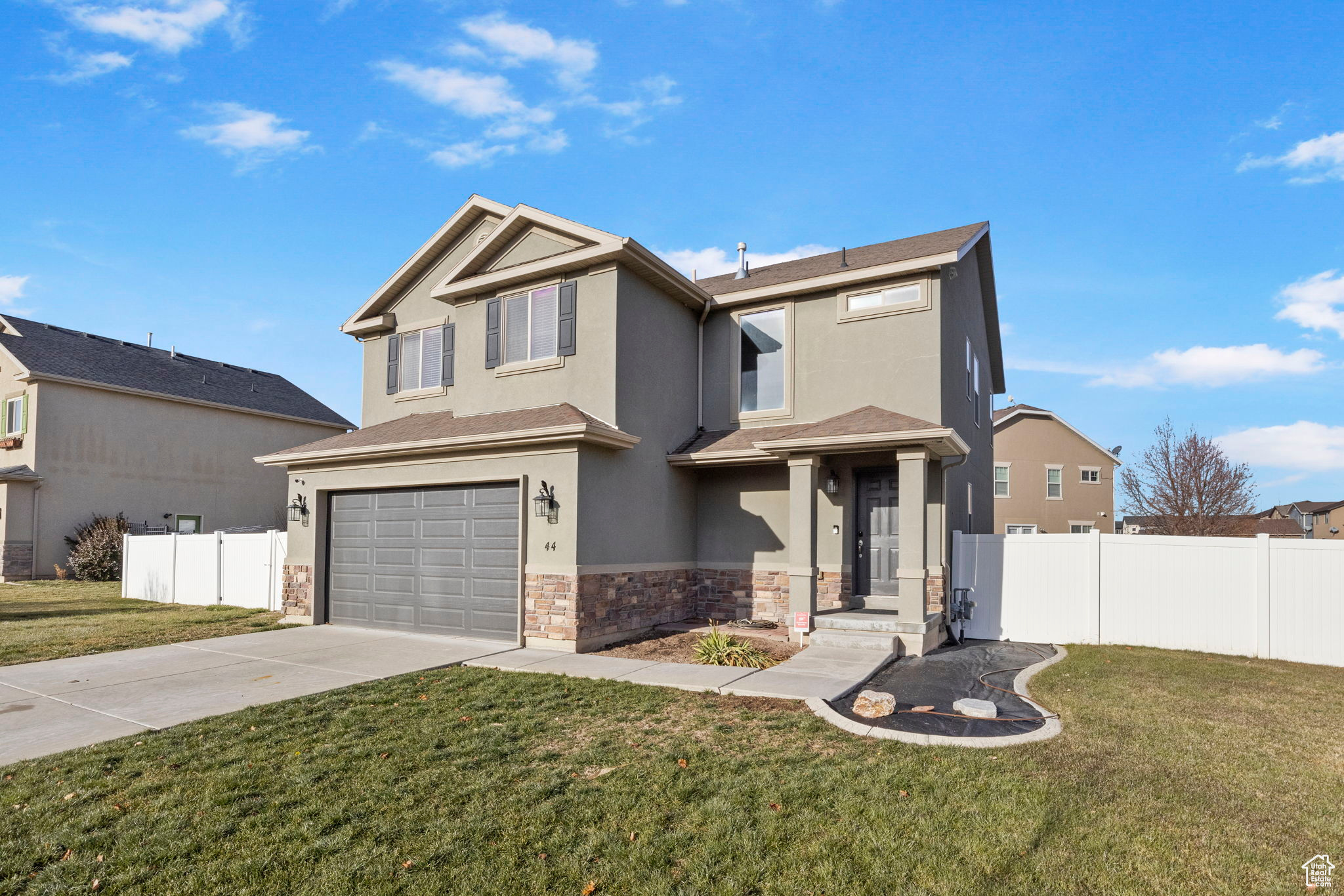 View of front of home featuring a garage and a front lawn