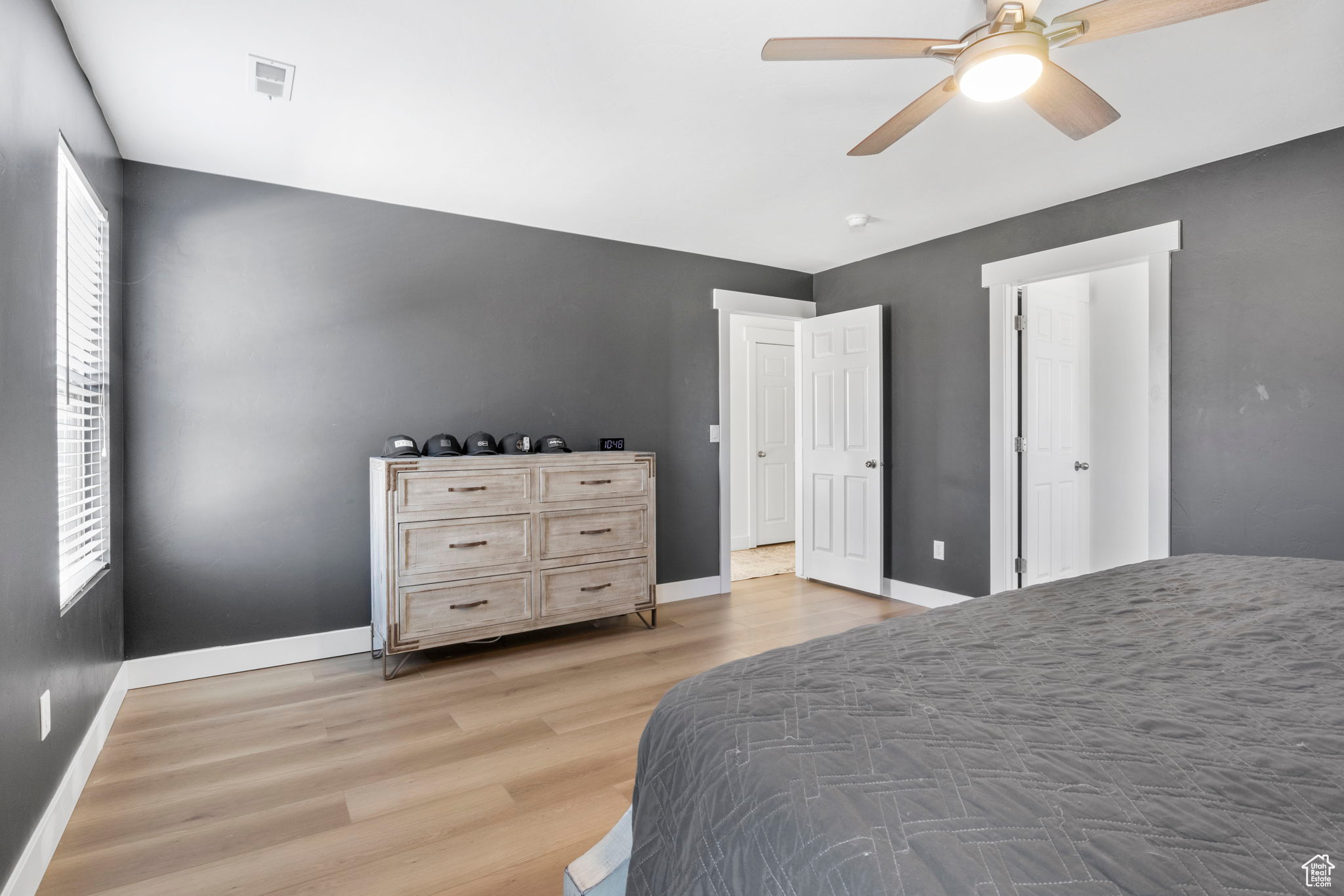 Bedroom with ceiling fan and light wood-type flooring