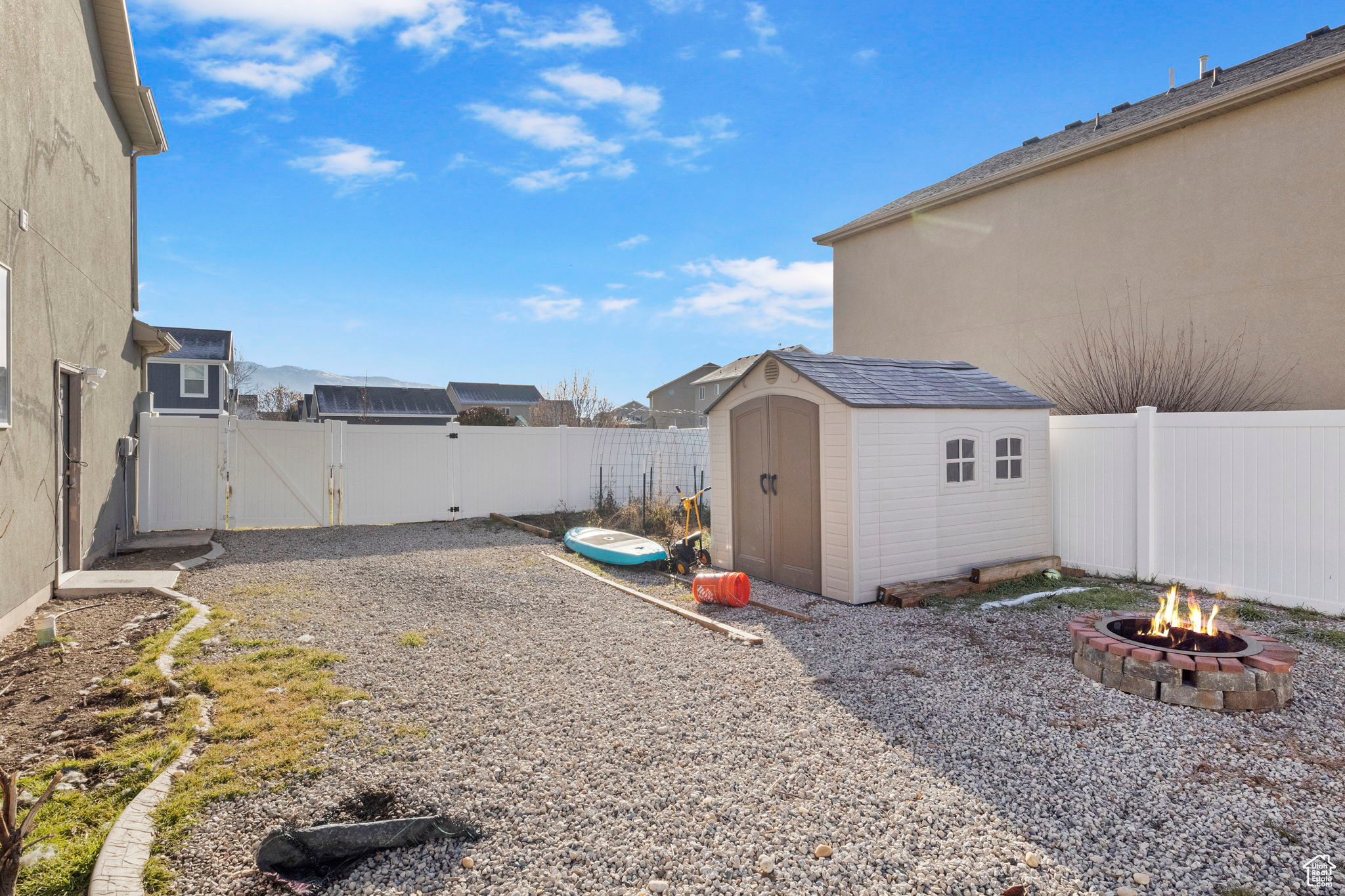 View of yard featuring a shed and a fire pit