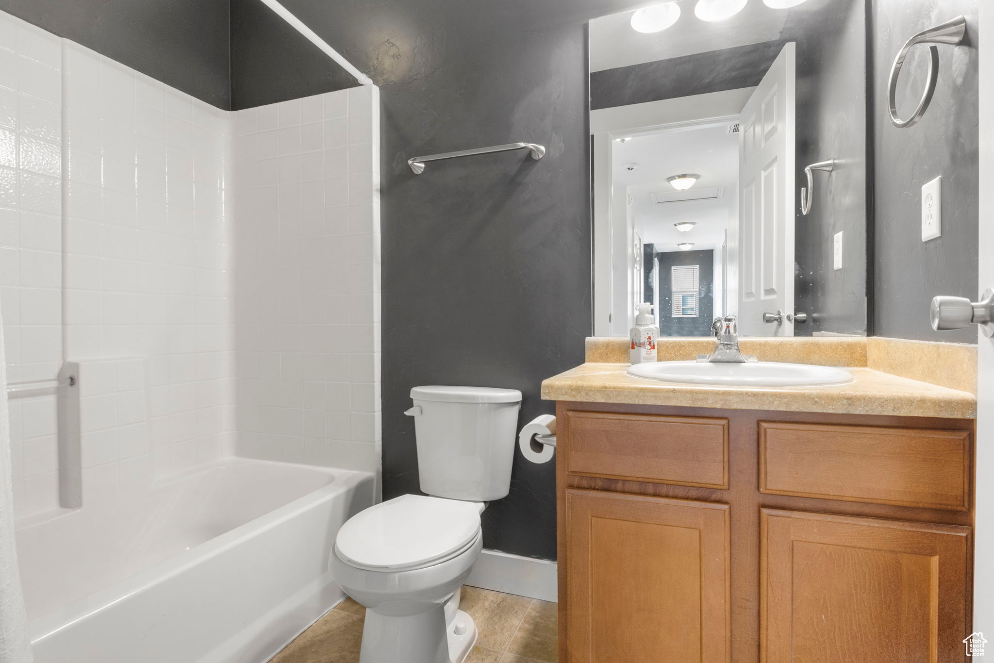 Full bathroom featuring vanity, toilet, and shower / washtub combination