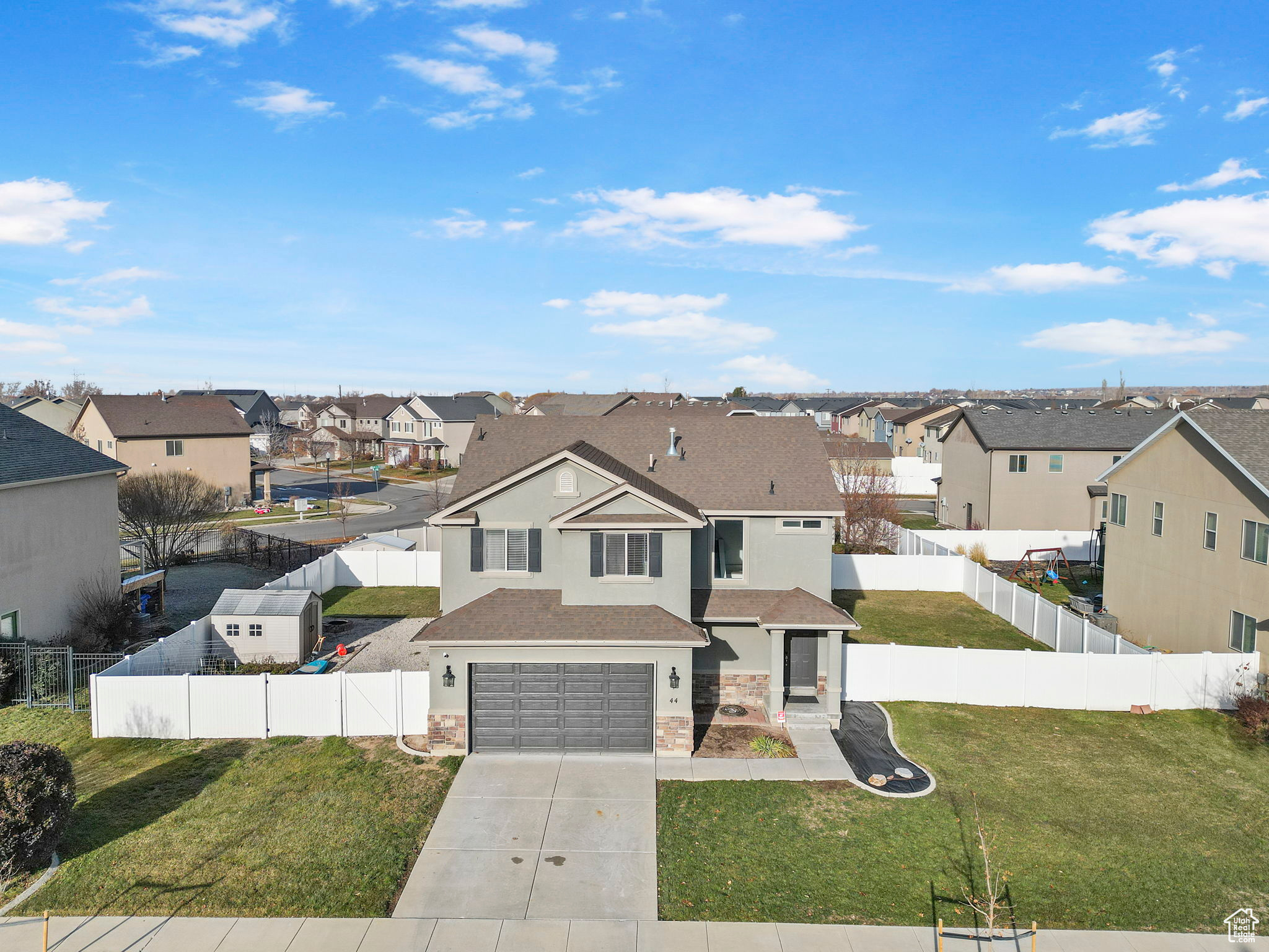 View of front facade with a garage and a front lawn