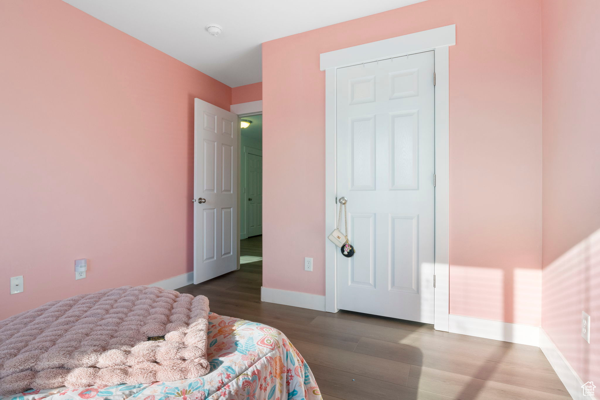 Bedroom with dark hardwood / wood-style floors