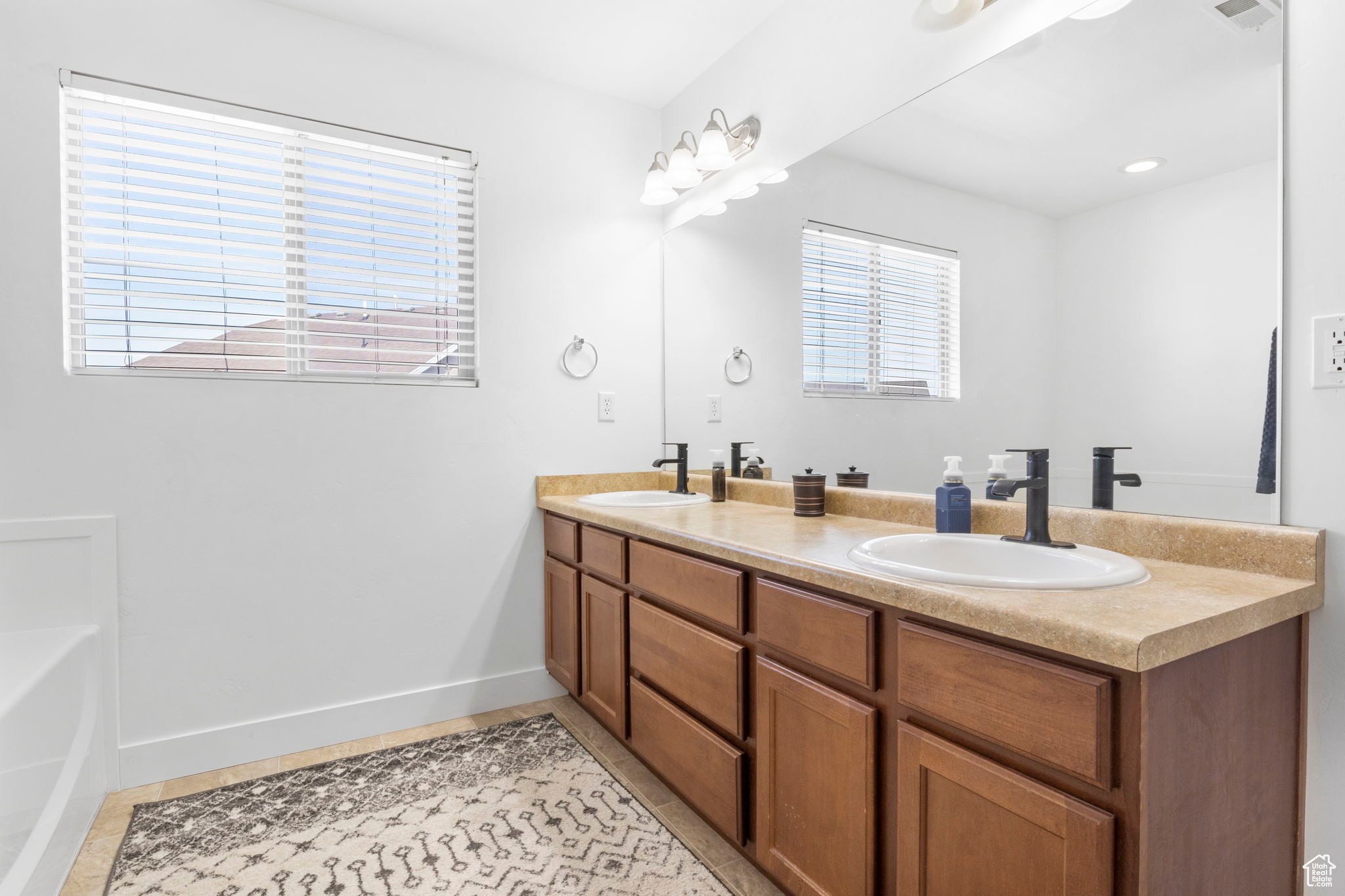 Bathroom featuring tile patterned flooring and vanity