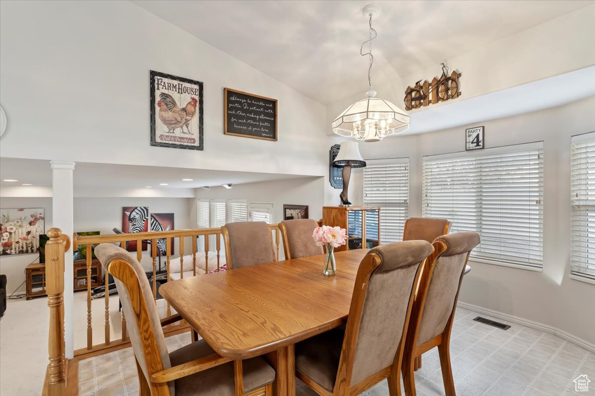 Dining area with vaulted ceiling and a chandelier