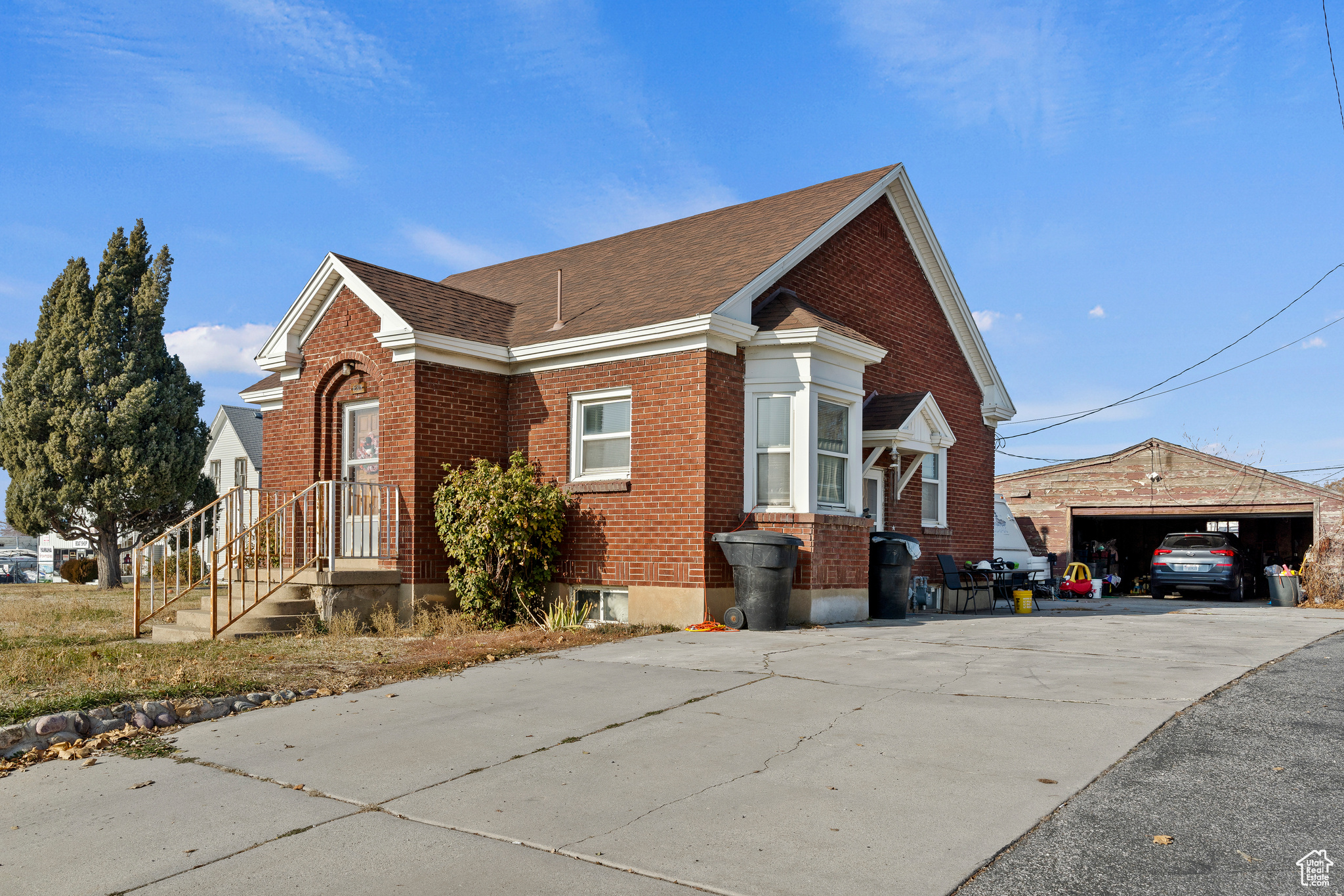 View of property exterior with an outdoor structure and a garage