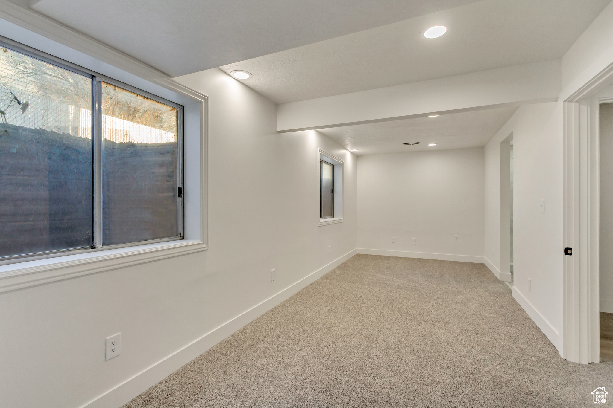 Basement featuring light carpet