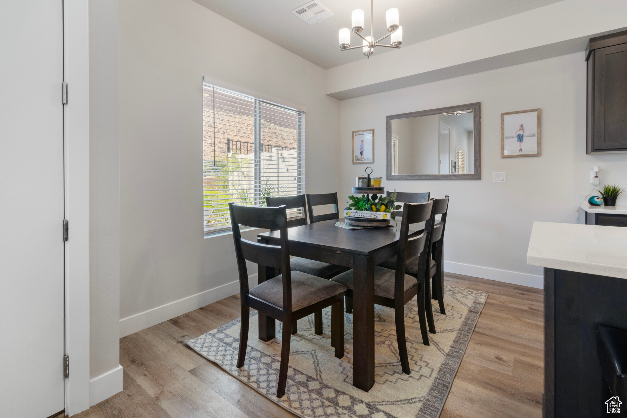 Dining space featuring light hardwood / wood-style floors and a notable chandelier