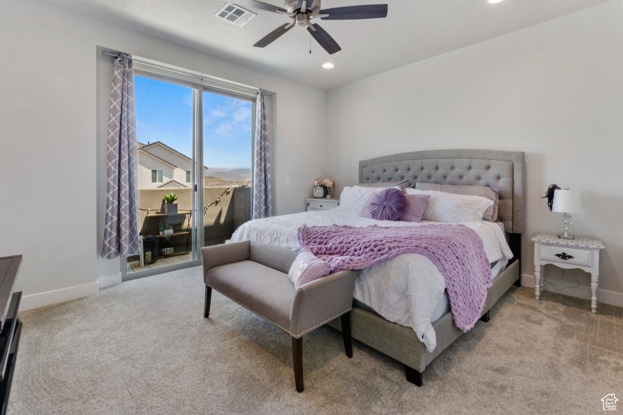 Carpeted bedroom featuring access to outside and ceiling fan