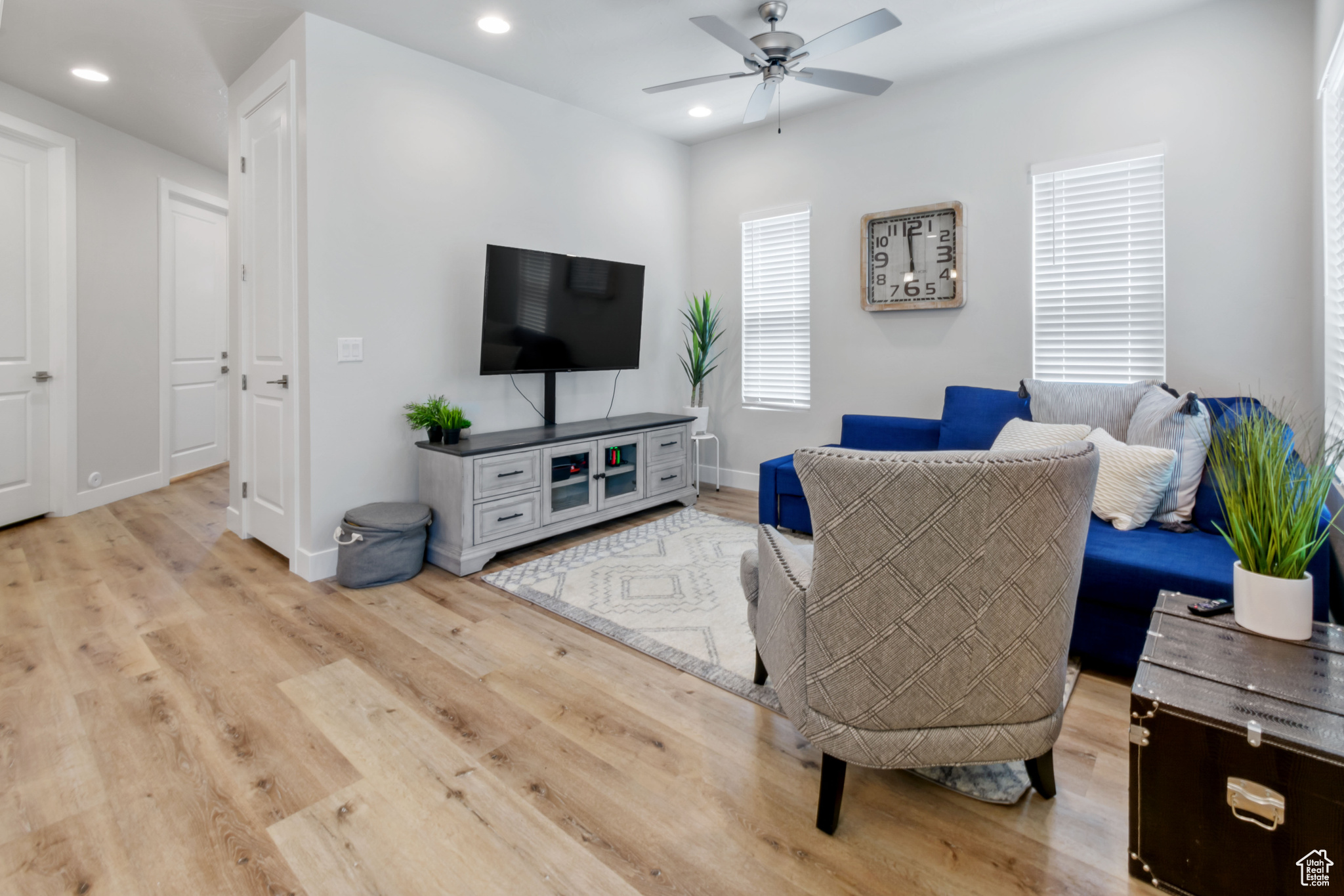 Living room featuring ceiling fan and light wood-type flooring