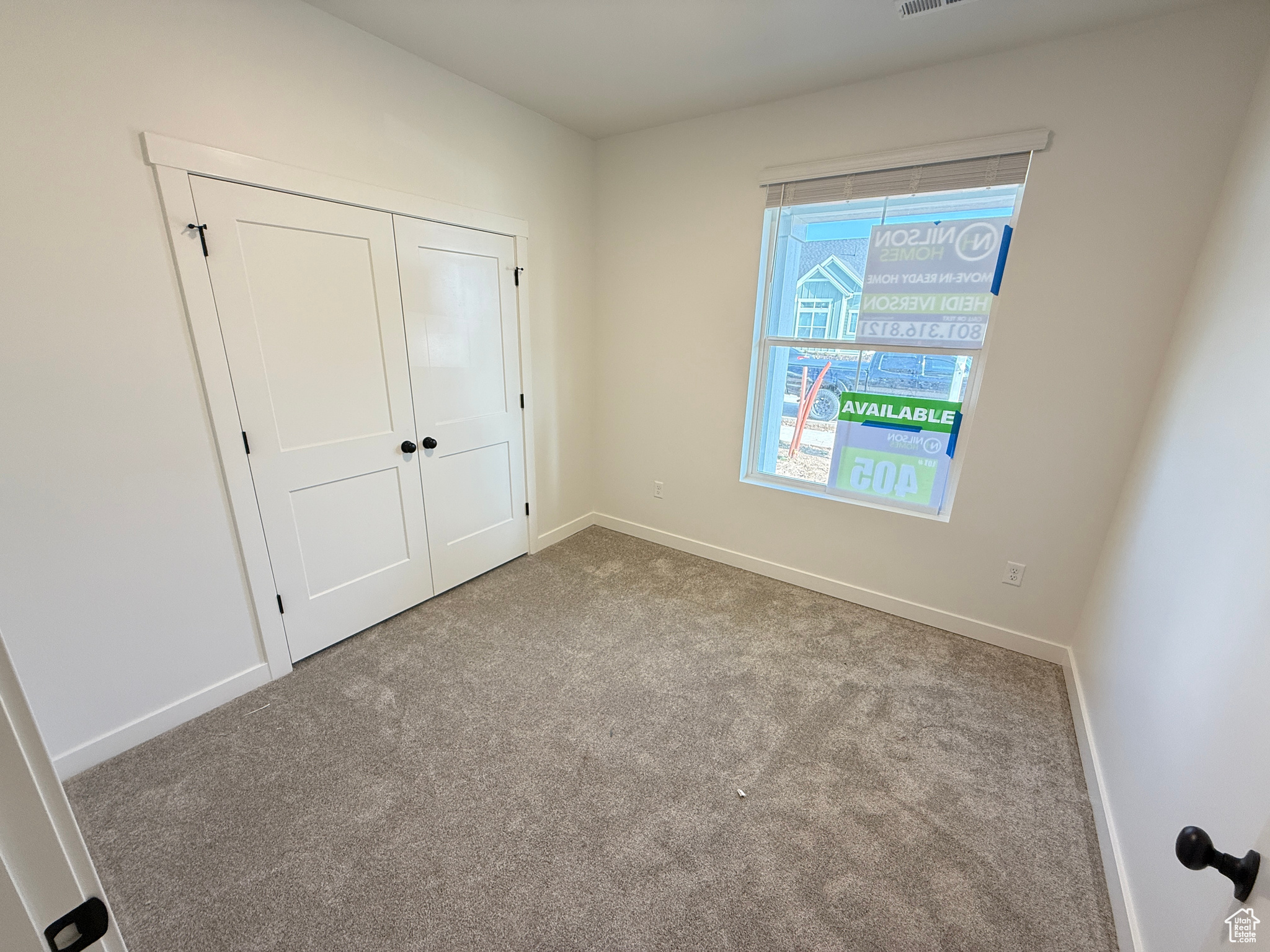 Unfurnished bedroom featuring light colored carpet and a closet