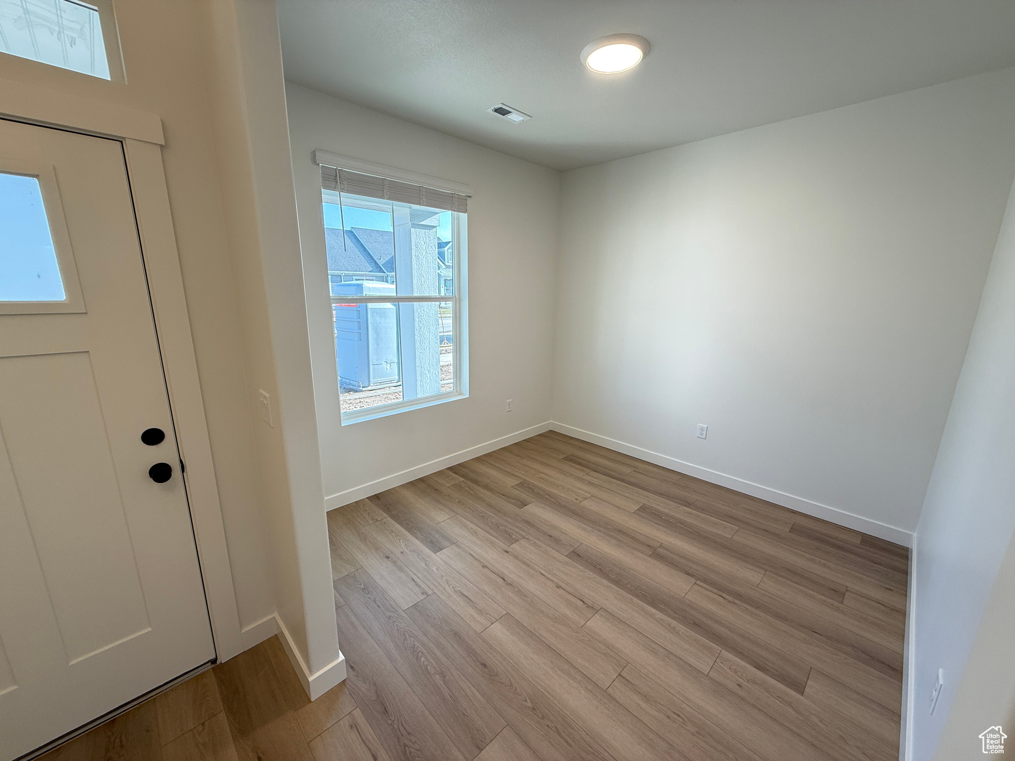 Foyer with light hardwood / wood-style floors