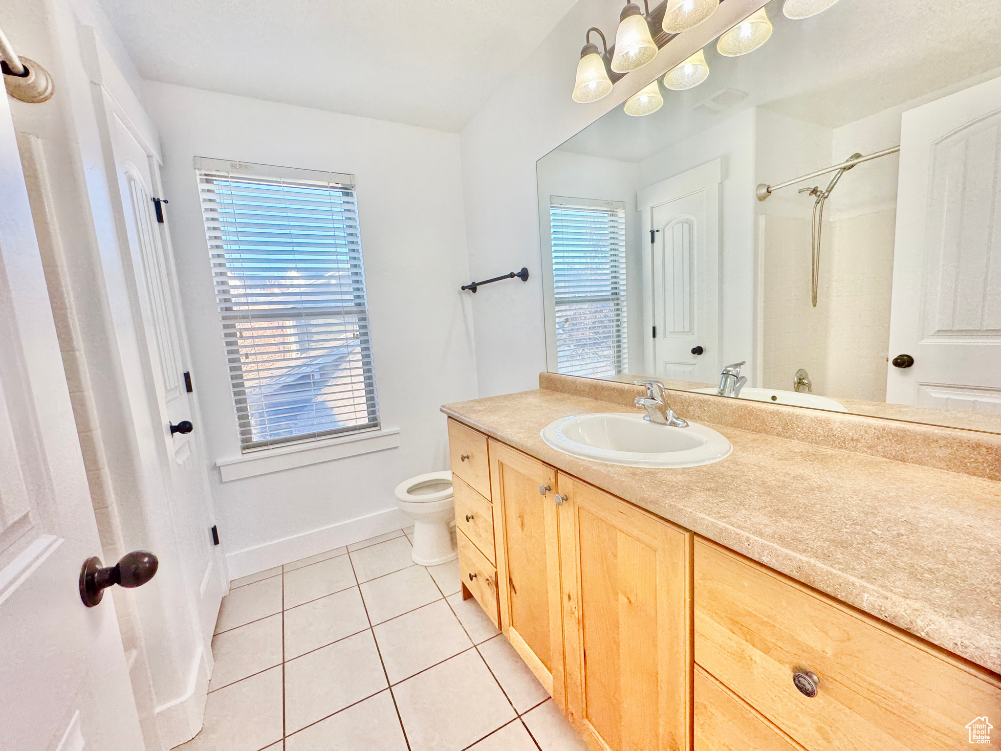 Bathroom with tile patterned flooring, vanity, and toilet