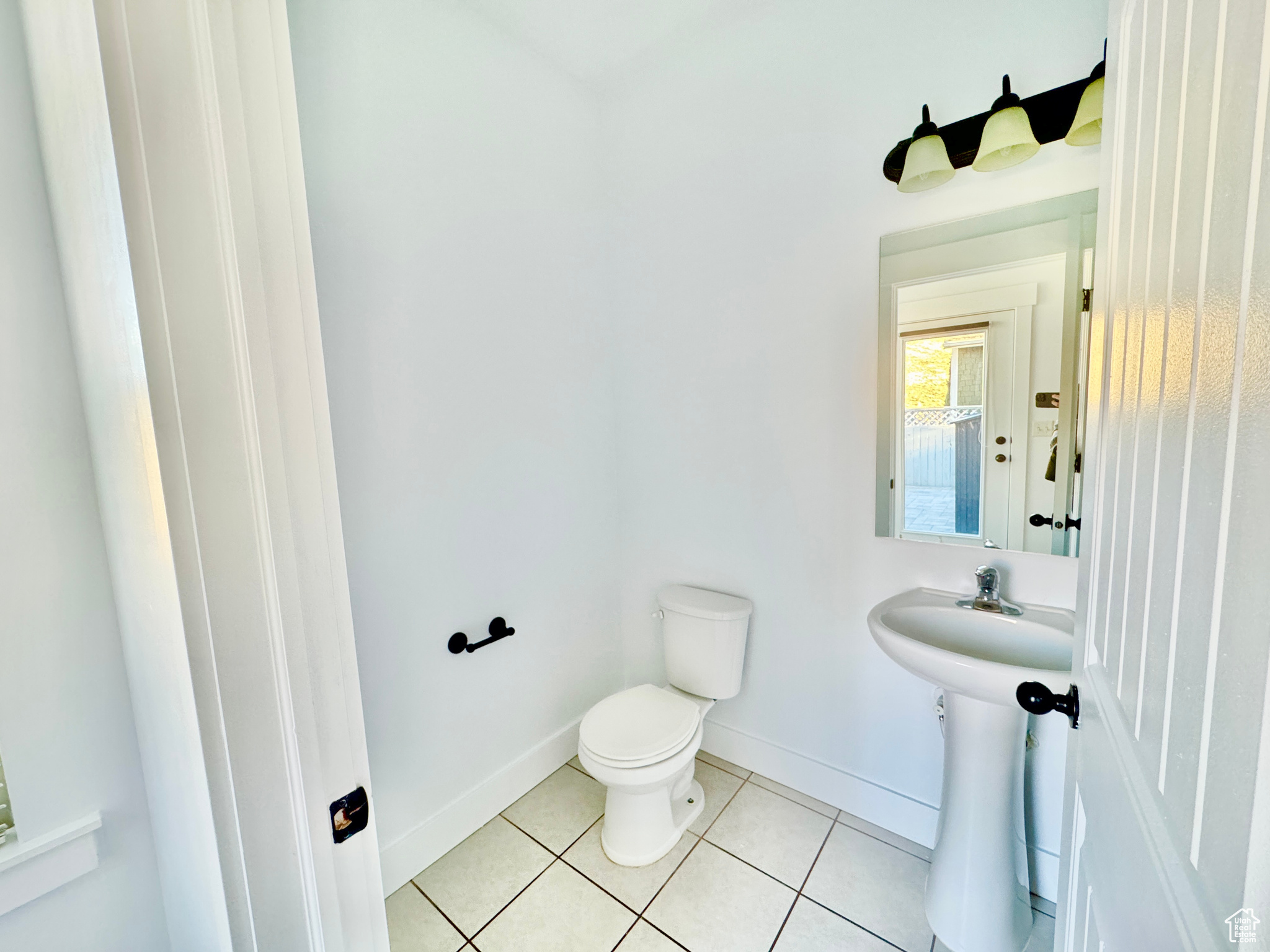 Bathroom with tile patterned floors and toilet