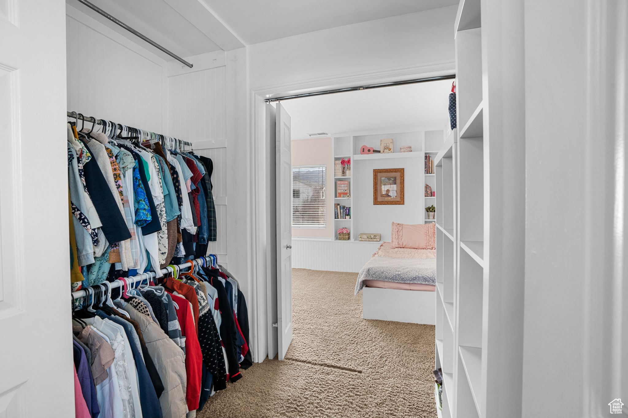 Walk in closet with carpet flooring